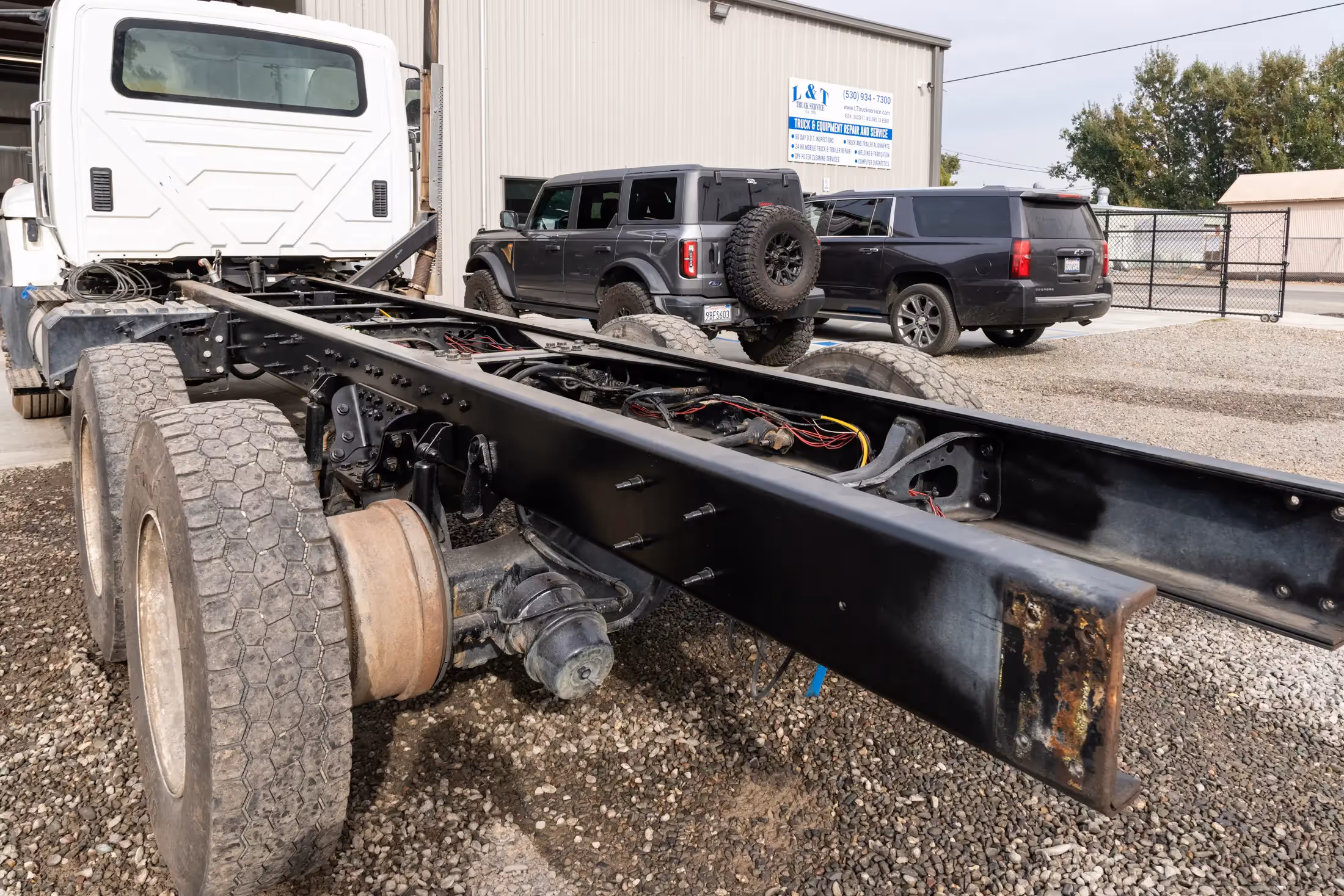 Diesel mechanic performing truck frame shortening service in Willows, CA