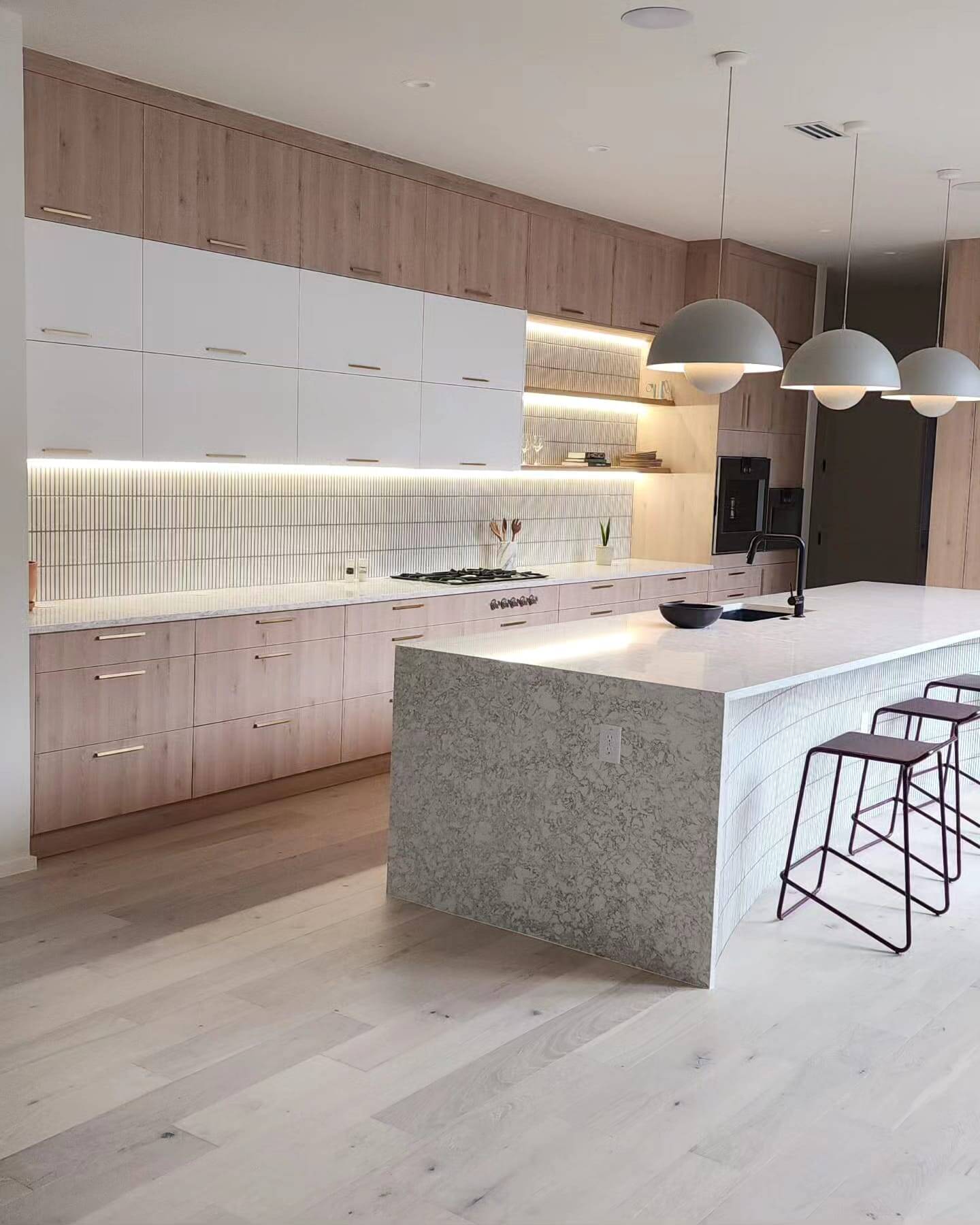 A close-up of a modern kitchen with a two-tone cabinet design.