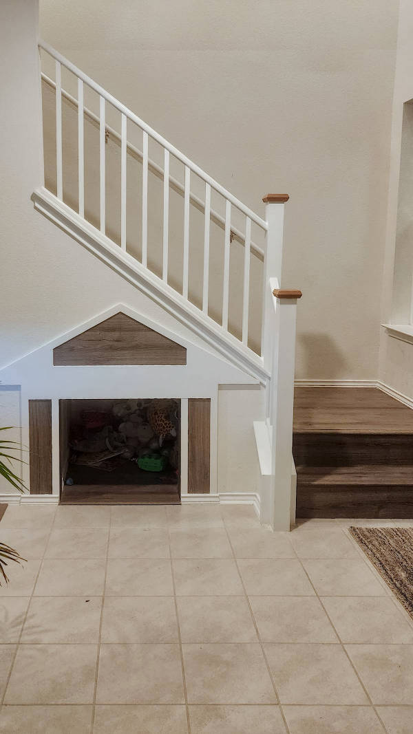 Custom under stairs dog house with ceiling lighting.
