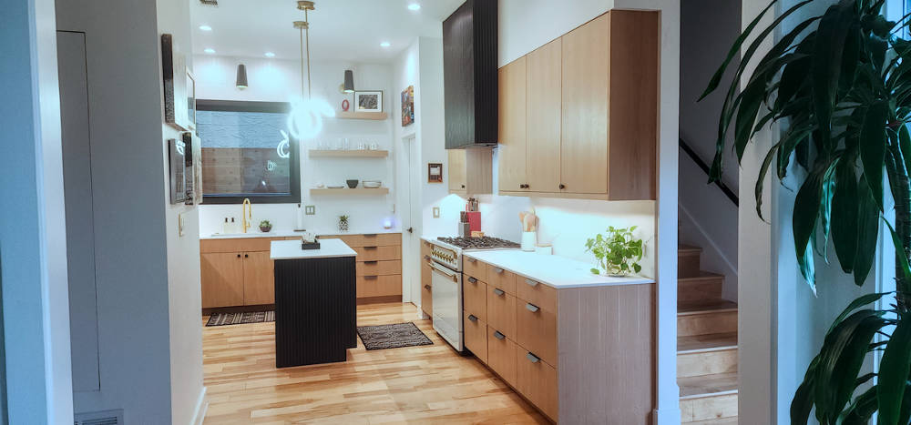 Custom riff sawn white oak kitchen cabinets with fluted painted island.