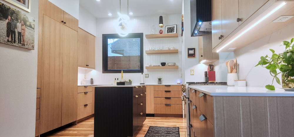 Custom riff sawn white oak kitchen cabinets with fluted painted island.