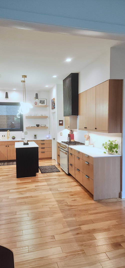 Custom riff sawn white oak kitchen cabinets with fluted painted island.