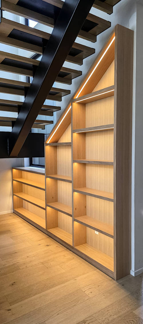 Custom built riff sawn white oak under stairs cabinet with LED lights.