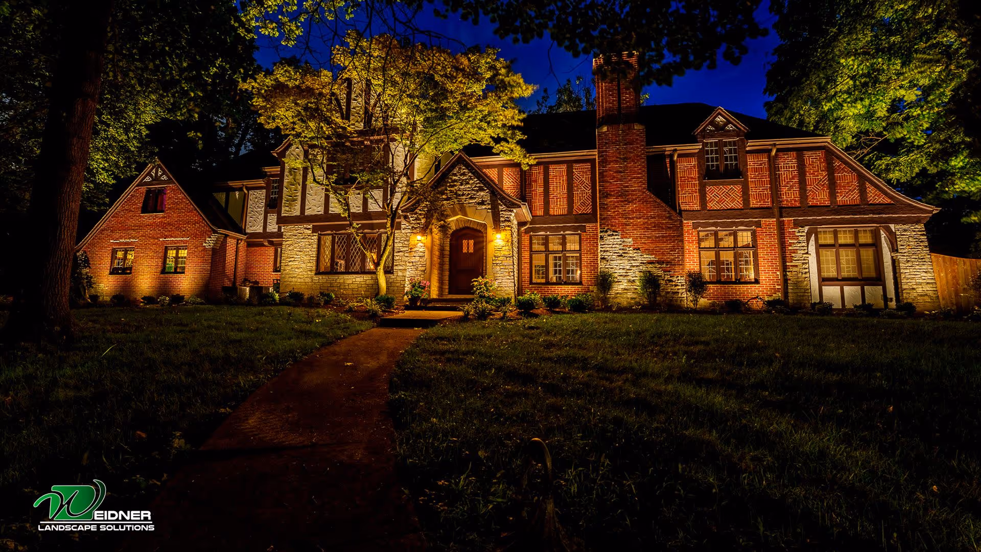 Outdoor landscape lighting highlighting plants and walkways by Weidner Landscape Solutions near me