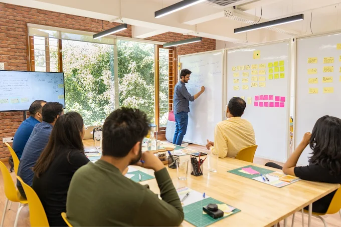 A guy working at Parallel explaining on whiteboard