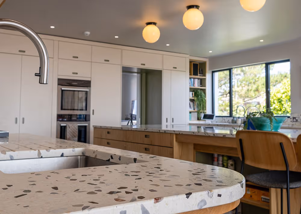A kitchen with a sink and a counter top.
