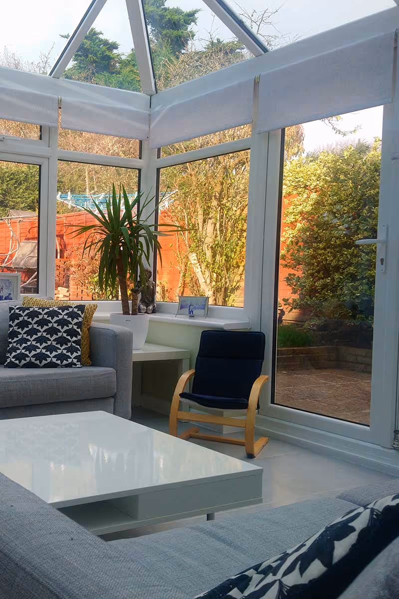 A living room filled with furniture and a large window.