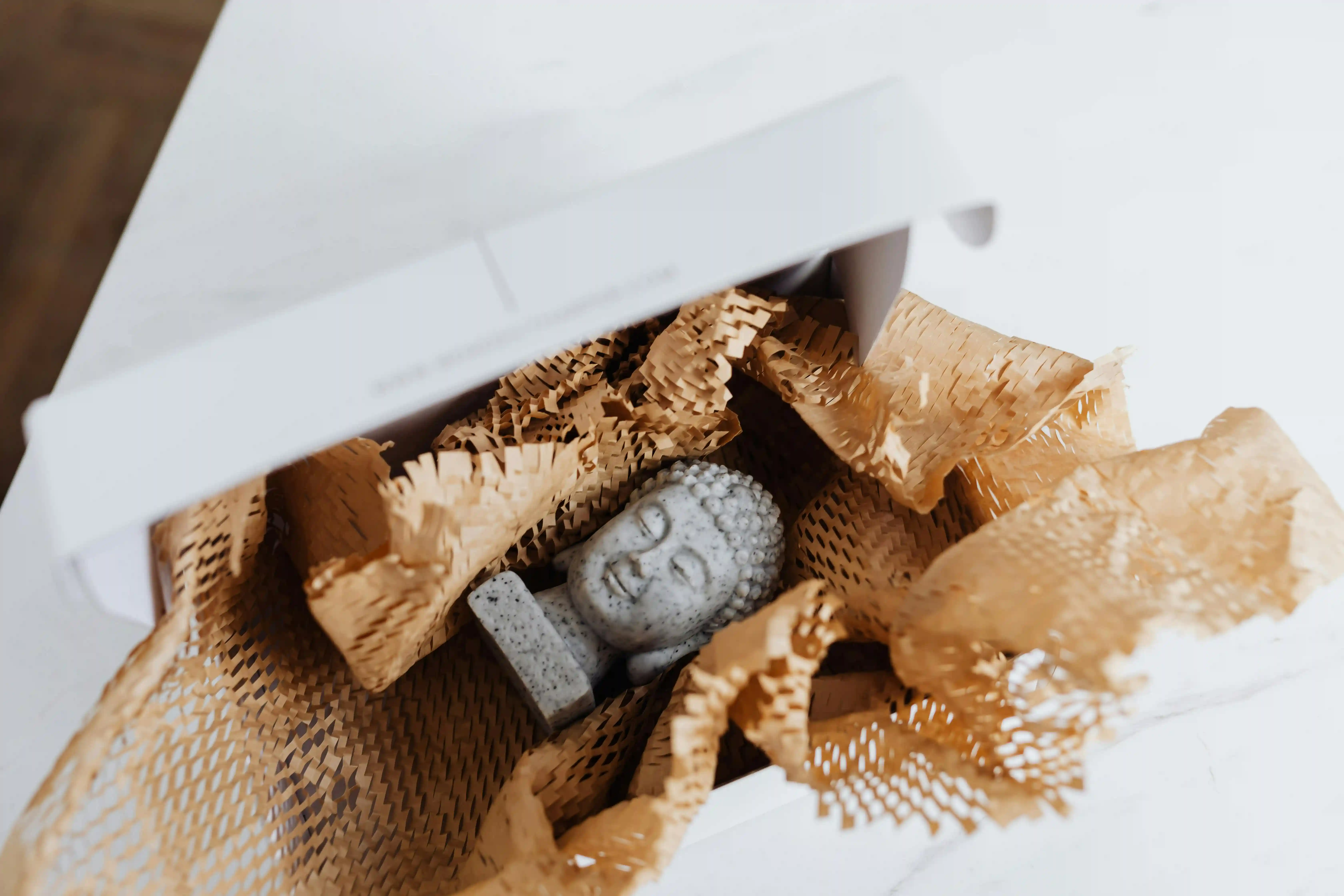 Budda head ornament inside an open package.