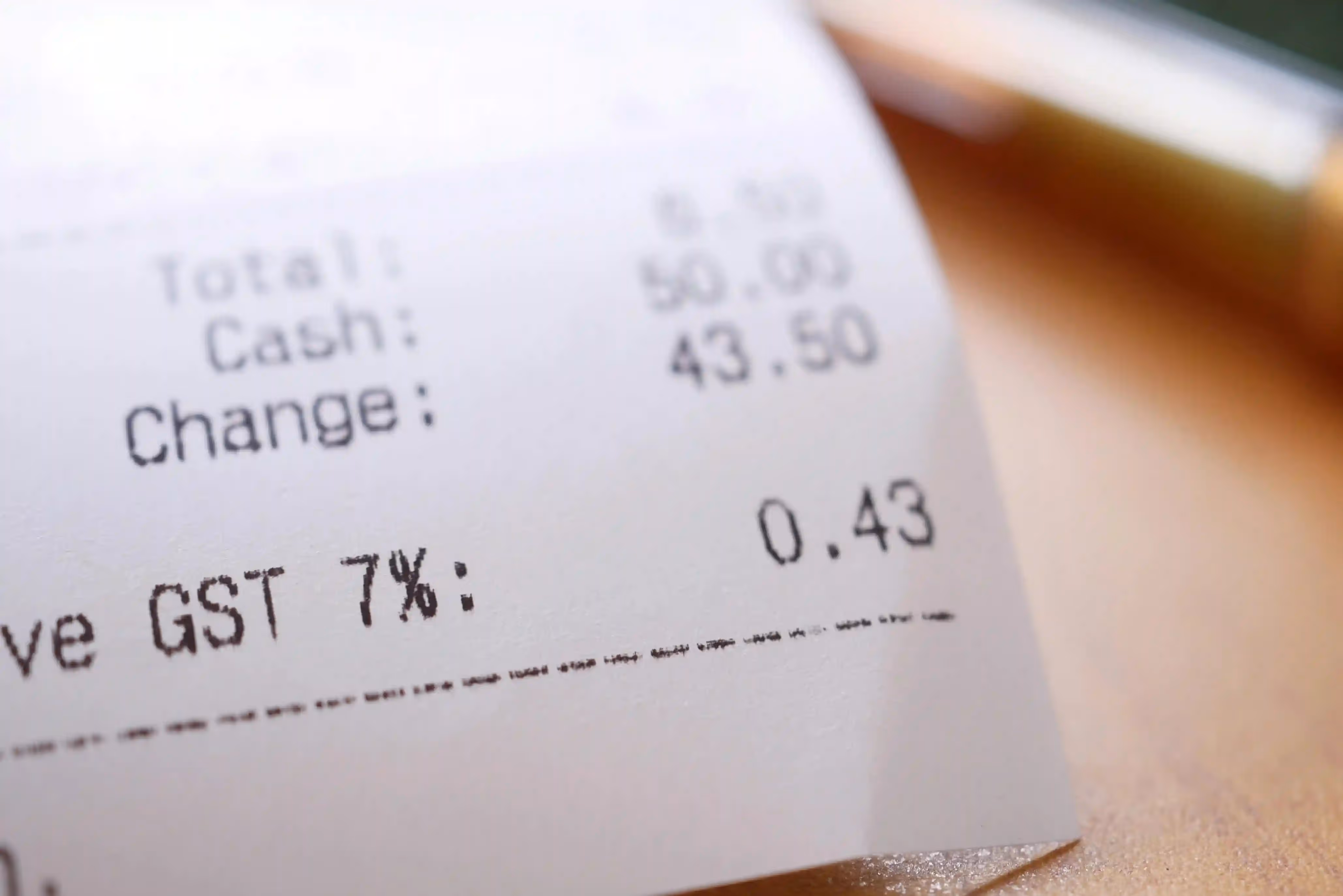 Close-up of a receipt showing 7% GST with a tax amount of 0.43.