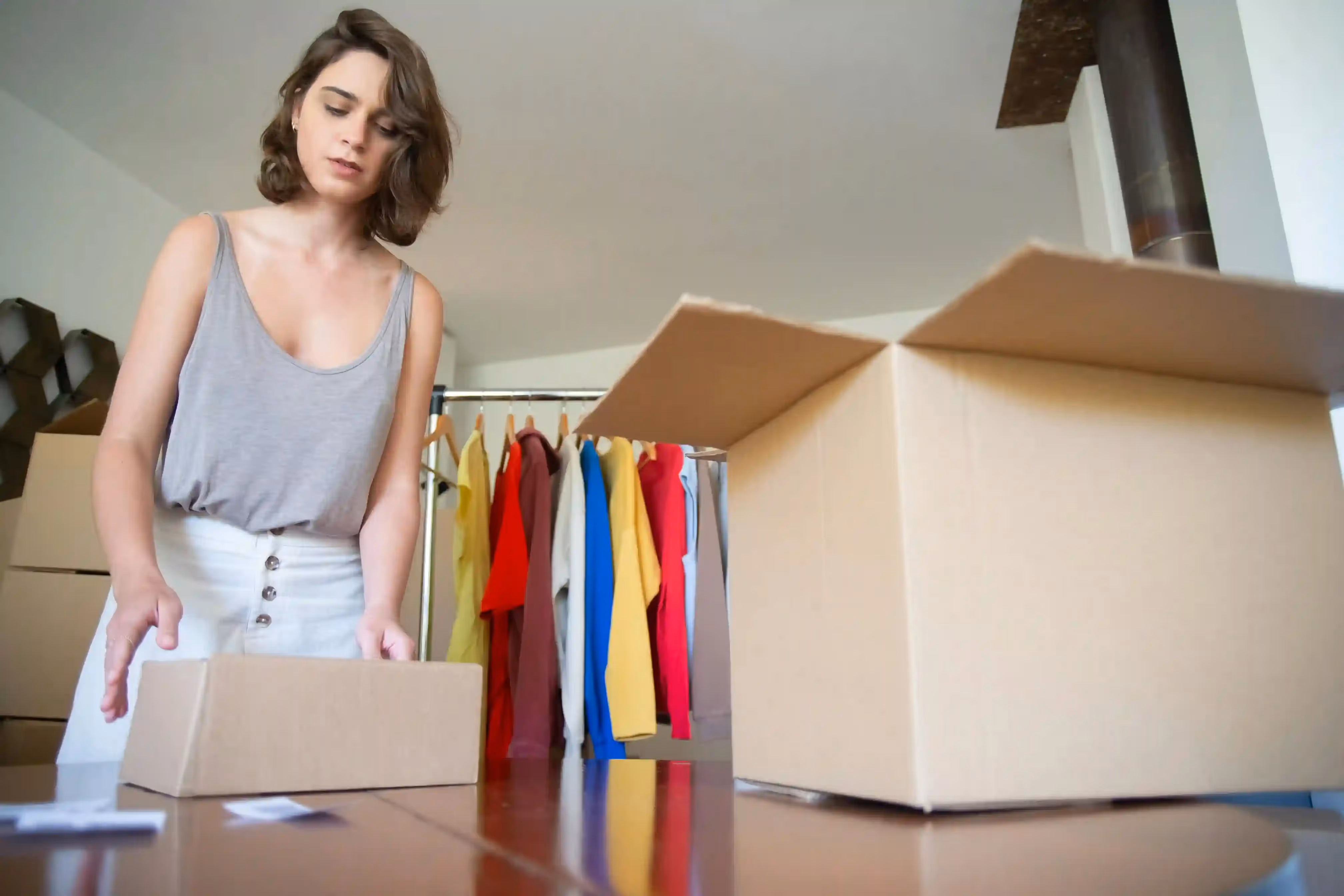 Woman preparing and boxing up packages.