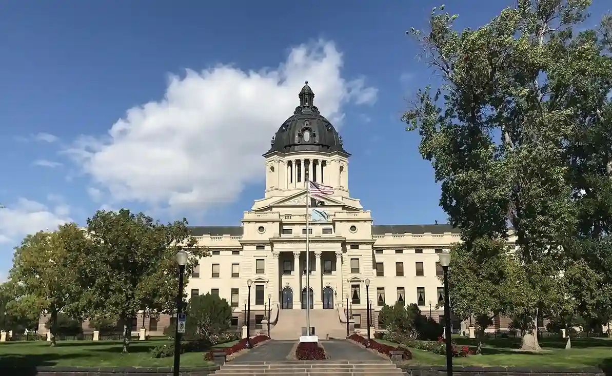 South Dakota State Capitol building with flags in front.