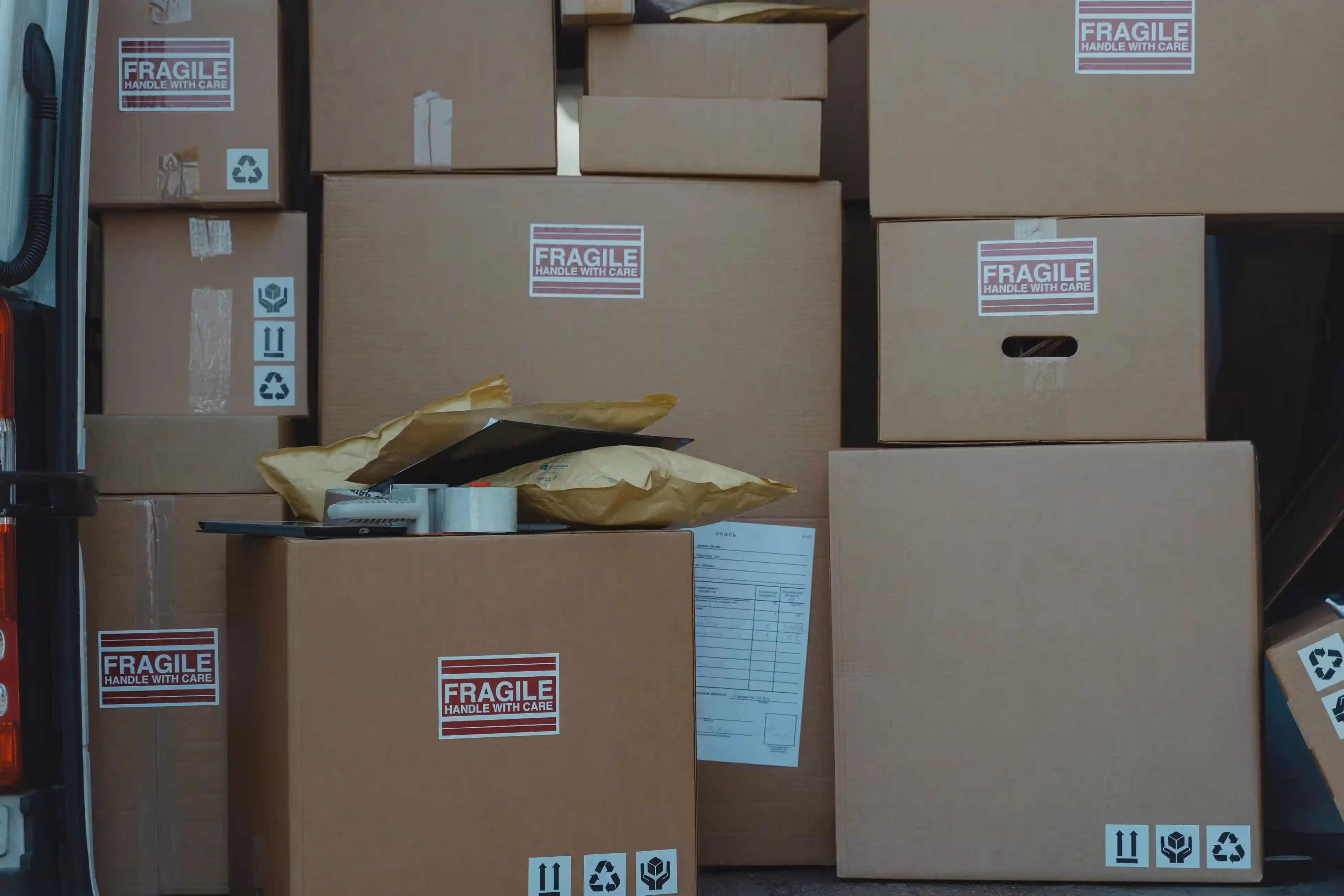 Stack of fragile-labeled cardboard boxes.