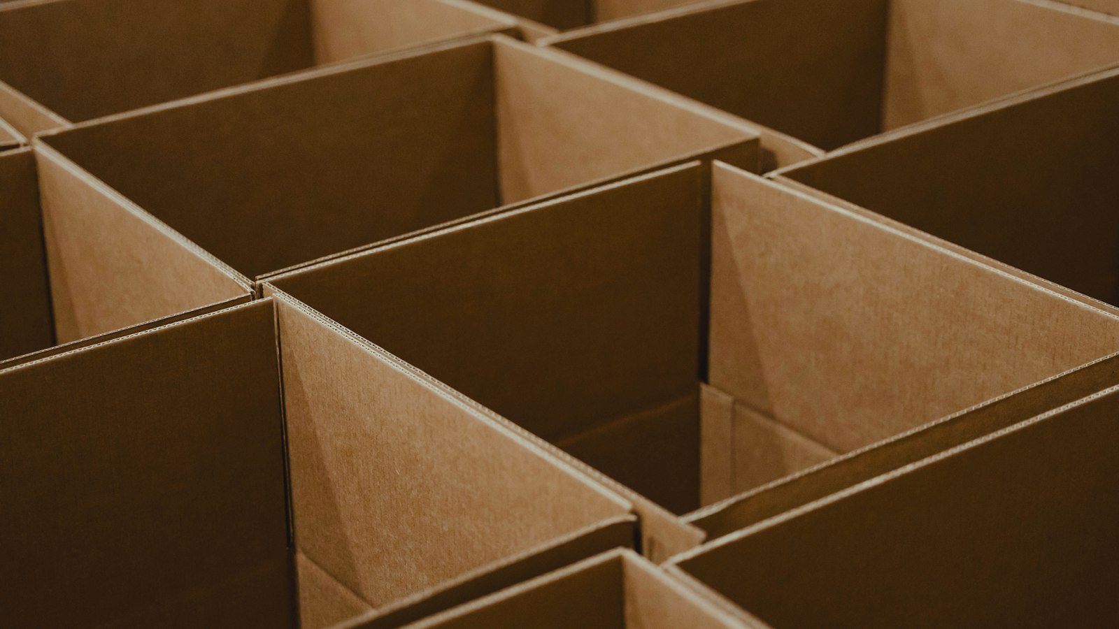 Pile of open brown cardboard boxes used as packaging for shipped goods