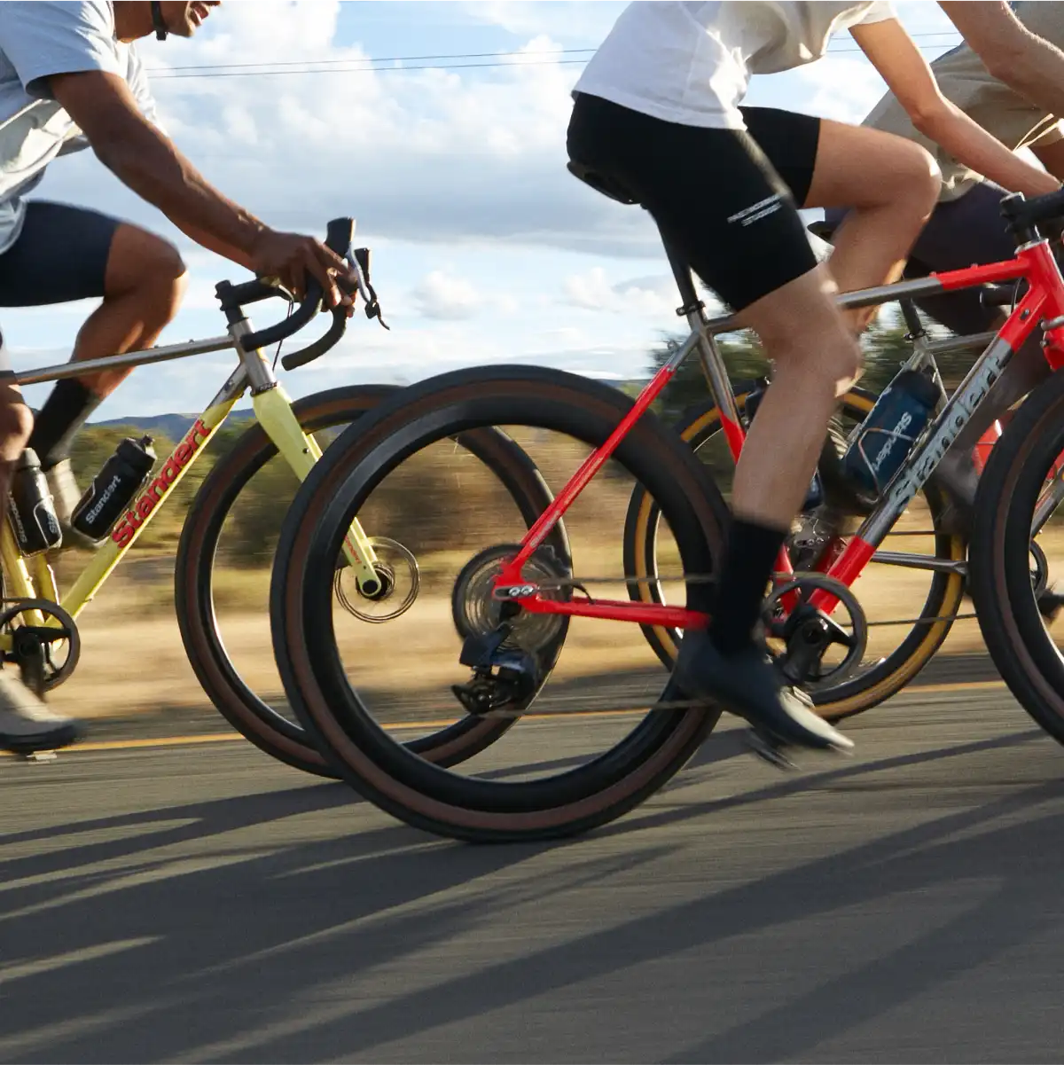 A group of people riding bikes down a street