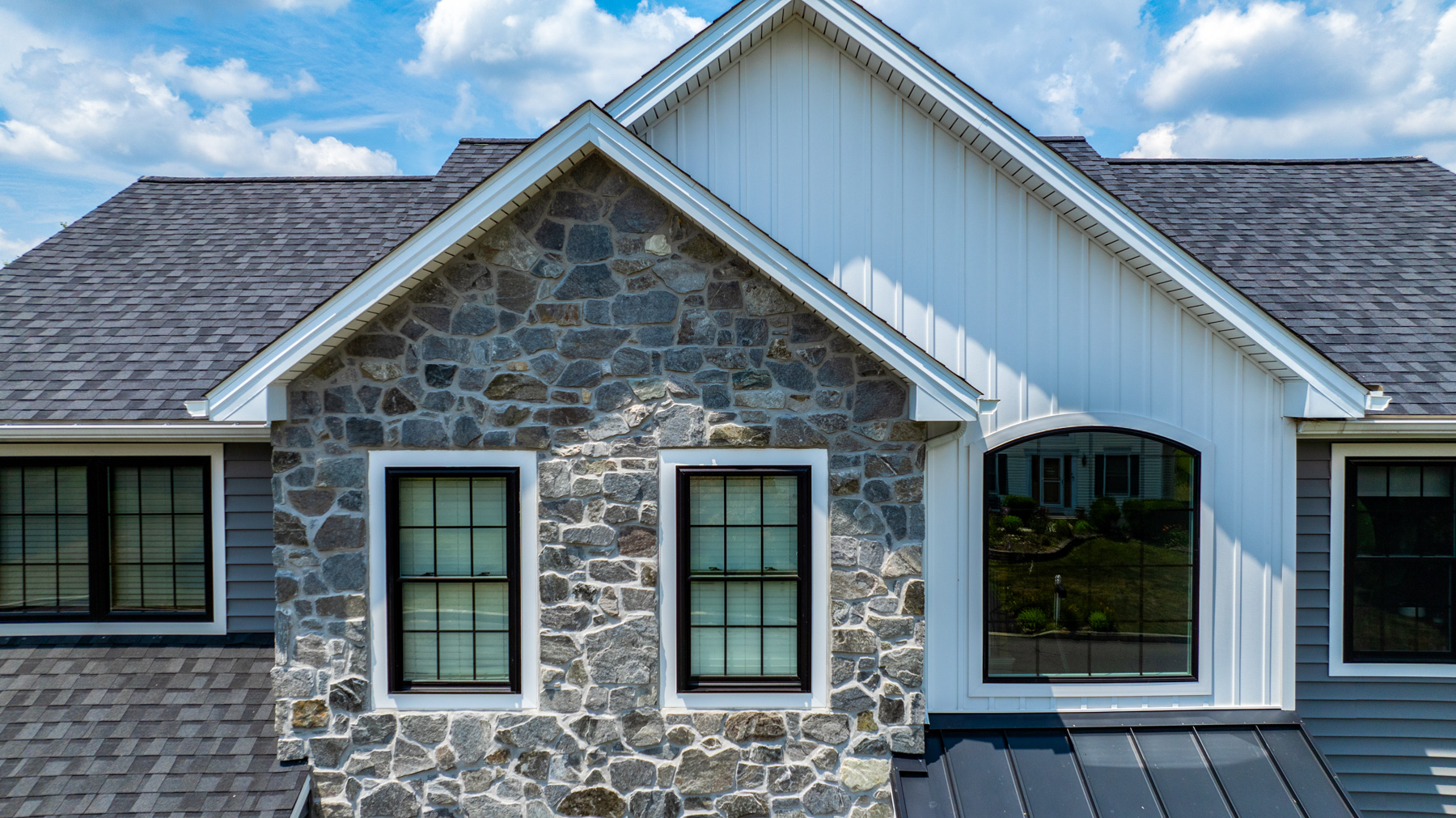 Image showing asphalt shingles and standing seam metal roofing on a home exterior renovation project