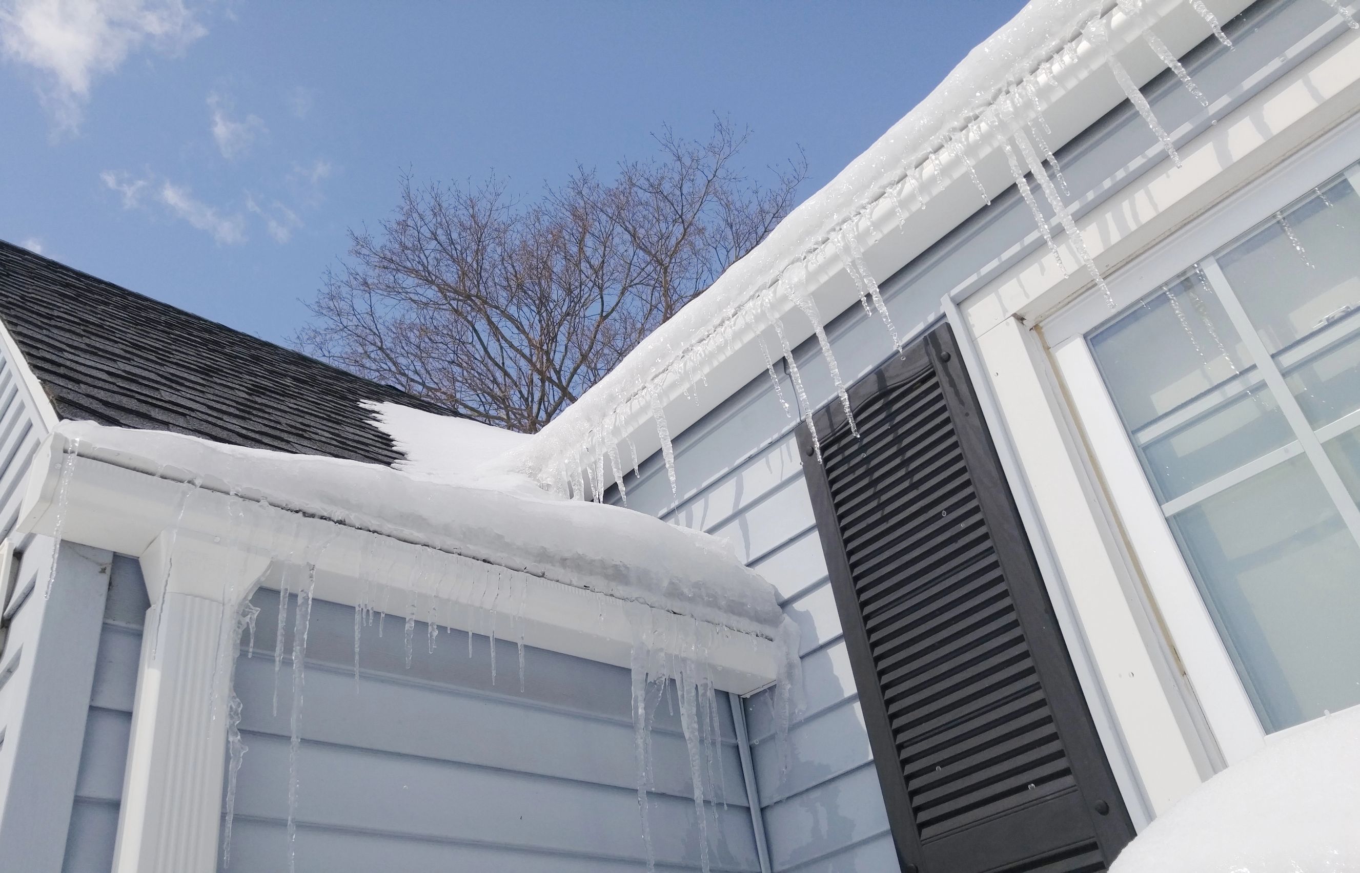 Ice dam on shingle roof in PA during the winter.