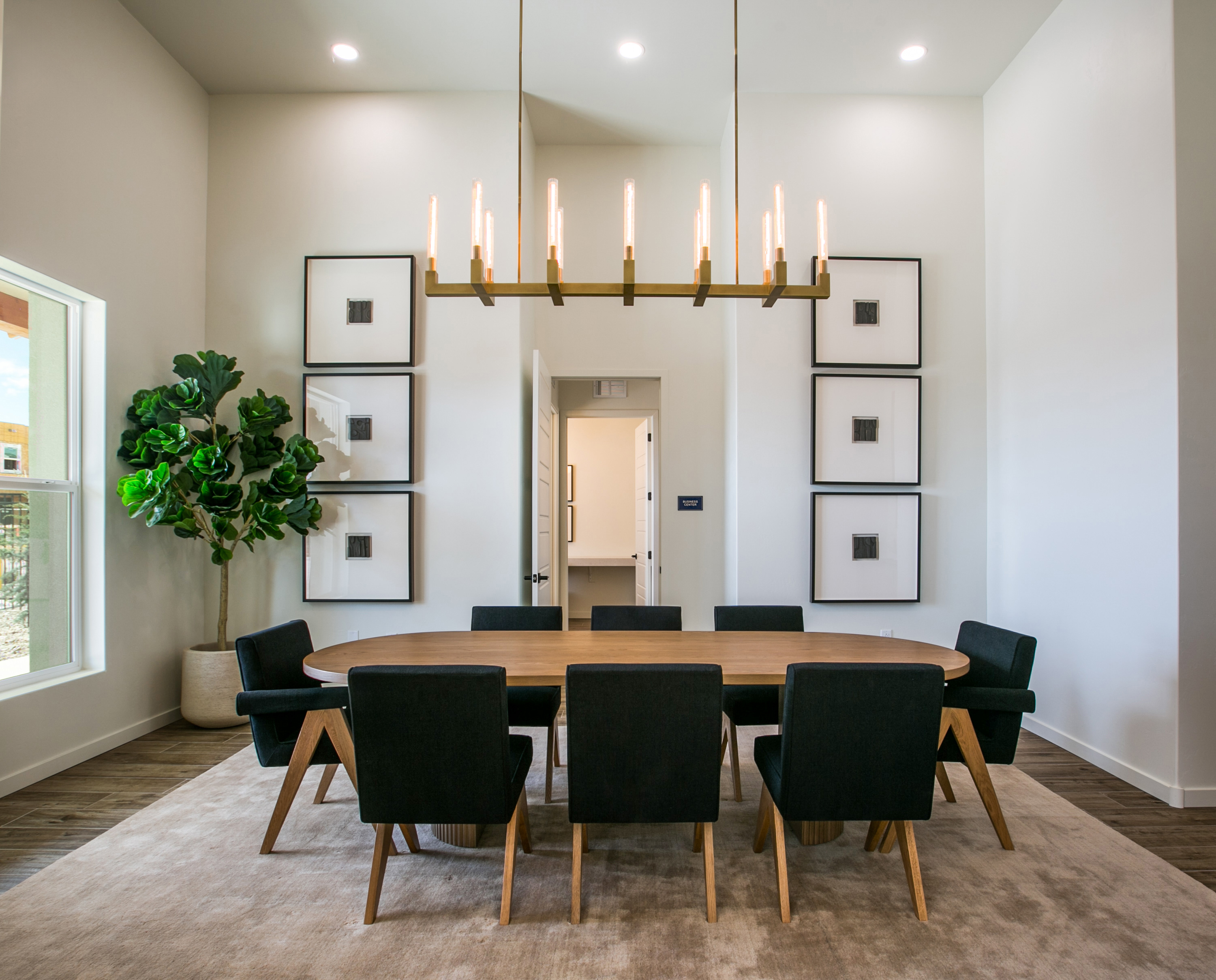 Grand lobby and resident lounge with high ceilings, mirrored wall decor, and modern furnishings, at The Eleanor at Rio Rancho in Rio Rancho, NM.