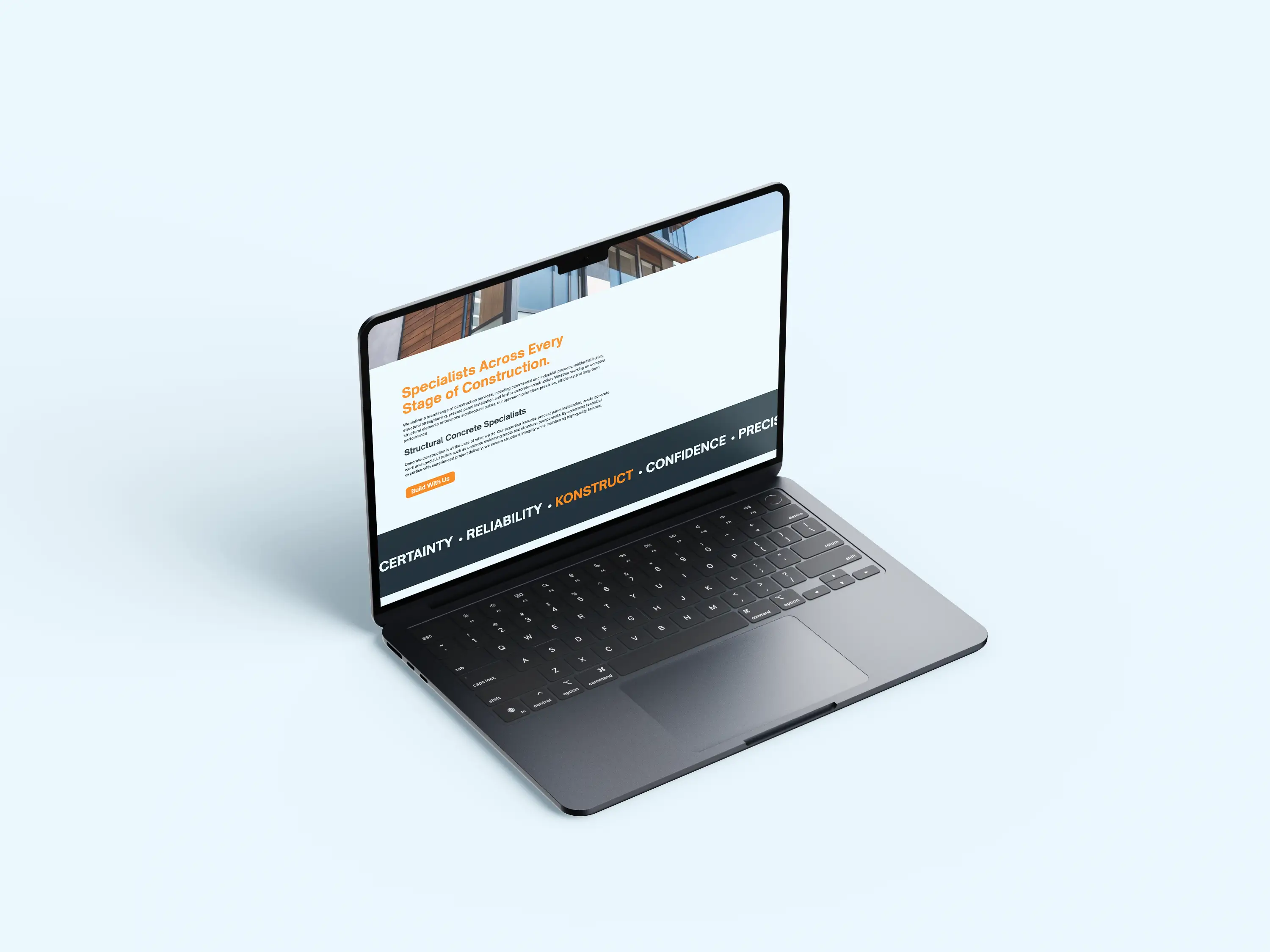 Open laptop on light blue surface showing a construction services webpage with text and orange highlights.