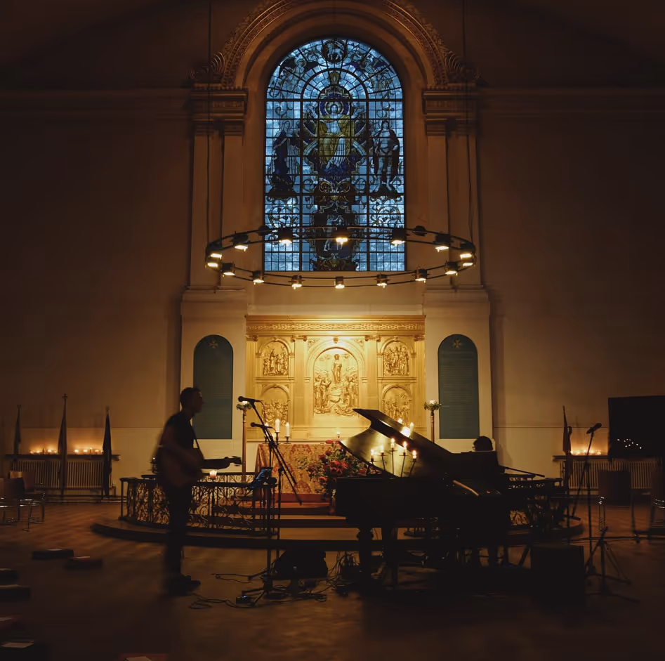 Musicians playing music in a dimly lit Church