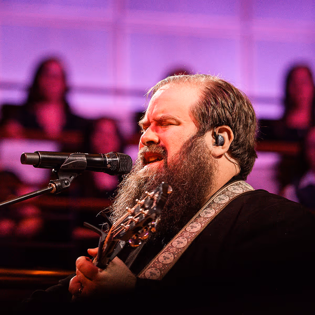 Dave Moore singing and playing the guitar.