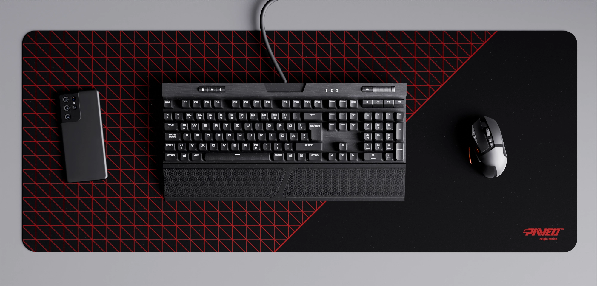 Top view of Night Imperial Net Runner XXL deskmat 1000mm x 400mm right-handed variant with minimalistic dense geometric net pattern in red and black, hydrophobic easy-to-clean antimicrobial surface, shown with full-size mechanical keyboard, gaming mouse, and smartphone for scale, 600% lighter non-slip base with no rubbery smell, durable stitch-free edges.
