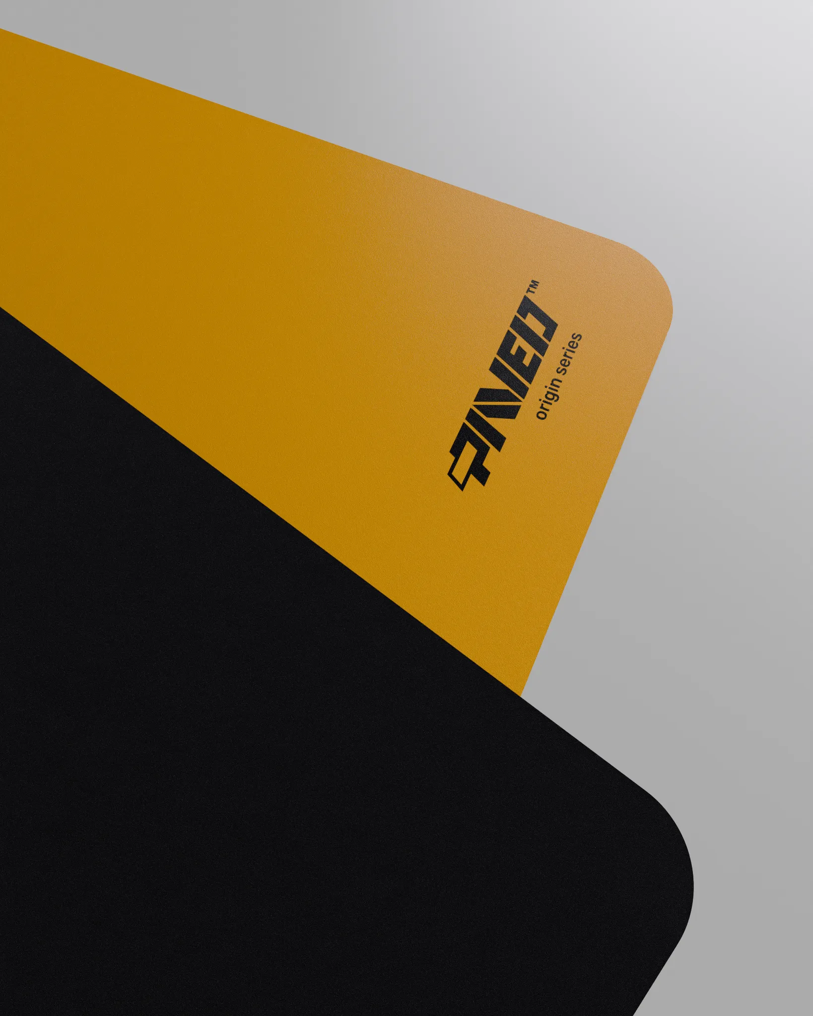 Close-up corner view of PAVED mousepad folded to reveal premium stitch-free edge finish with rounded corners, PAVED Origins logo in black, deep yellow easy clean surface with durable water-resistant finish and non-slip odour-free microruber base.