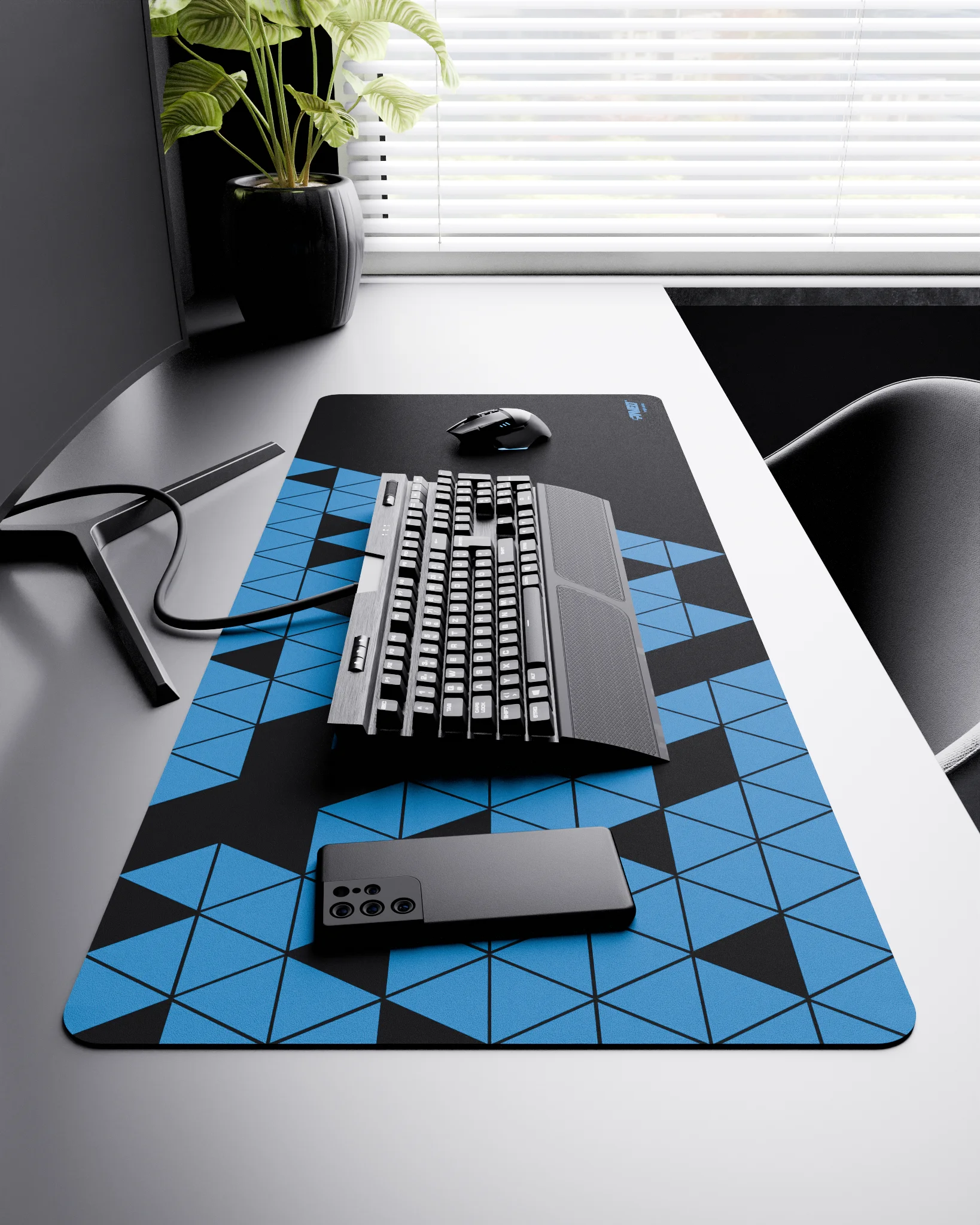 Side view of Night Sky Prism XXL deskmat 1000mm x 400mm right-handed layout on minimalist desk with gaming accessories, featuring blue geometric triangular prism pattern, water-resistant easy-to-clean surface, ultra-lightweight and odour-free base.
