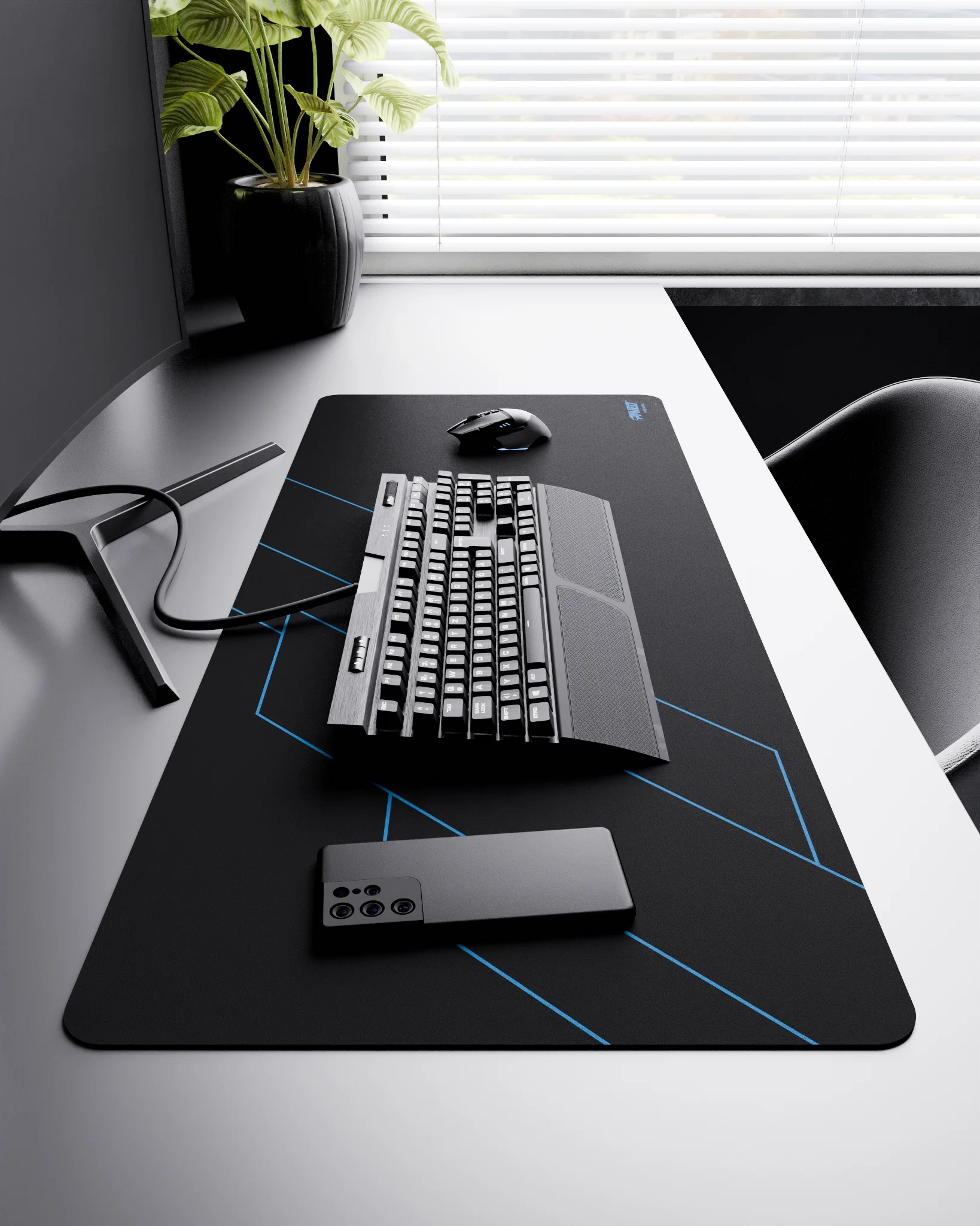 Side view of Night Sky Formula XXL deskmat 1000mm x 400mm right-handed layout on minimalist desk with gaming accessories, featuring blue geometric angular line pattern, water-resistant easy-to-clean surface, ultra-lightweight and odour-free base.