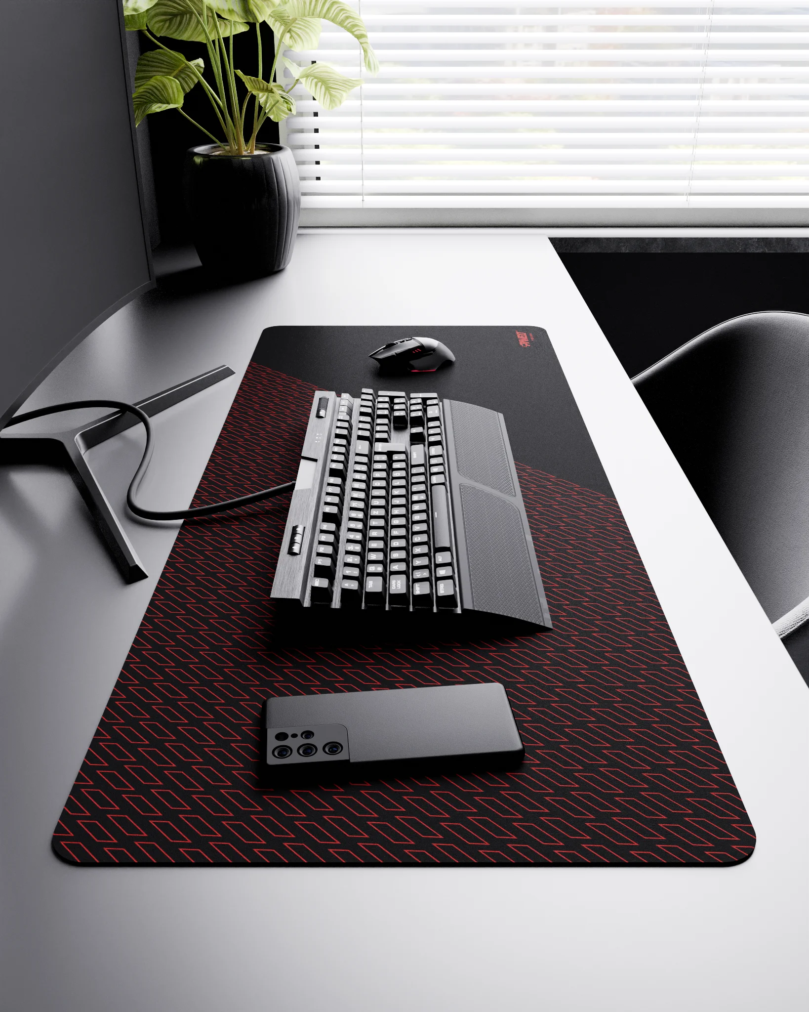 Side view of Night Imperial Pathfinder XXL deskmat 1000mm x 400mm right-handed layout on minimalist desk with gaming accessories, featuring red geometric tiled pattern, water-resistant easy-to-clean surface, ultra-lightweight and odour-free base.
