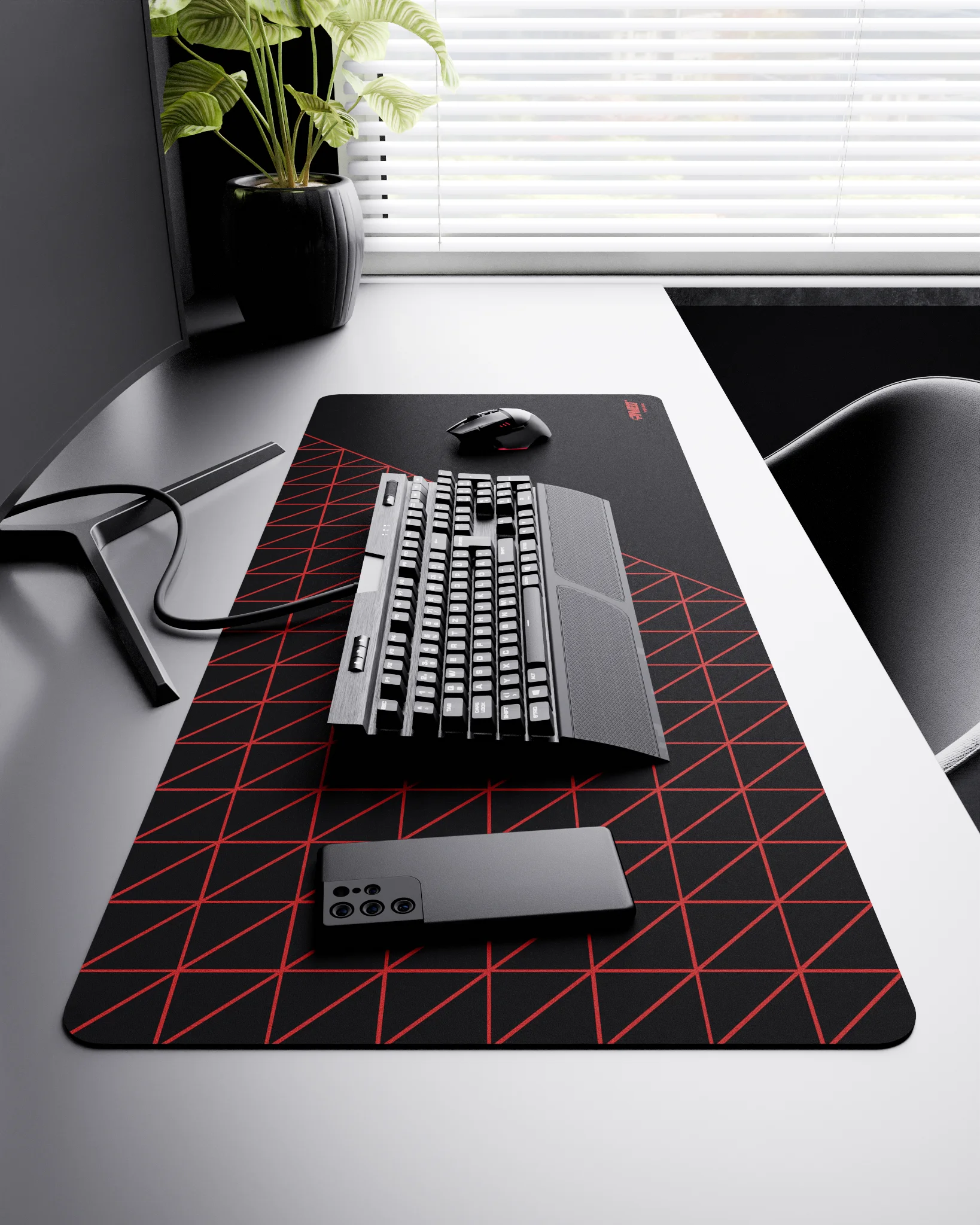 Side view of Night Imperial Grid Runner XXL deskmat 1000mm x 400mm right-handed layout on minimalist desk with gaming accessories, featuring red geometric grid pattern, water-resistant easy-to-clean surface, ultra-lightweight and odour-free base.