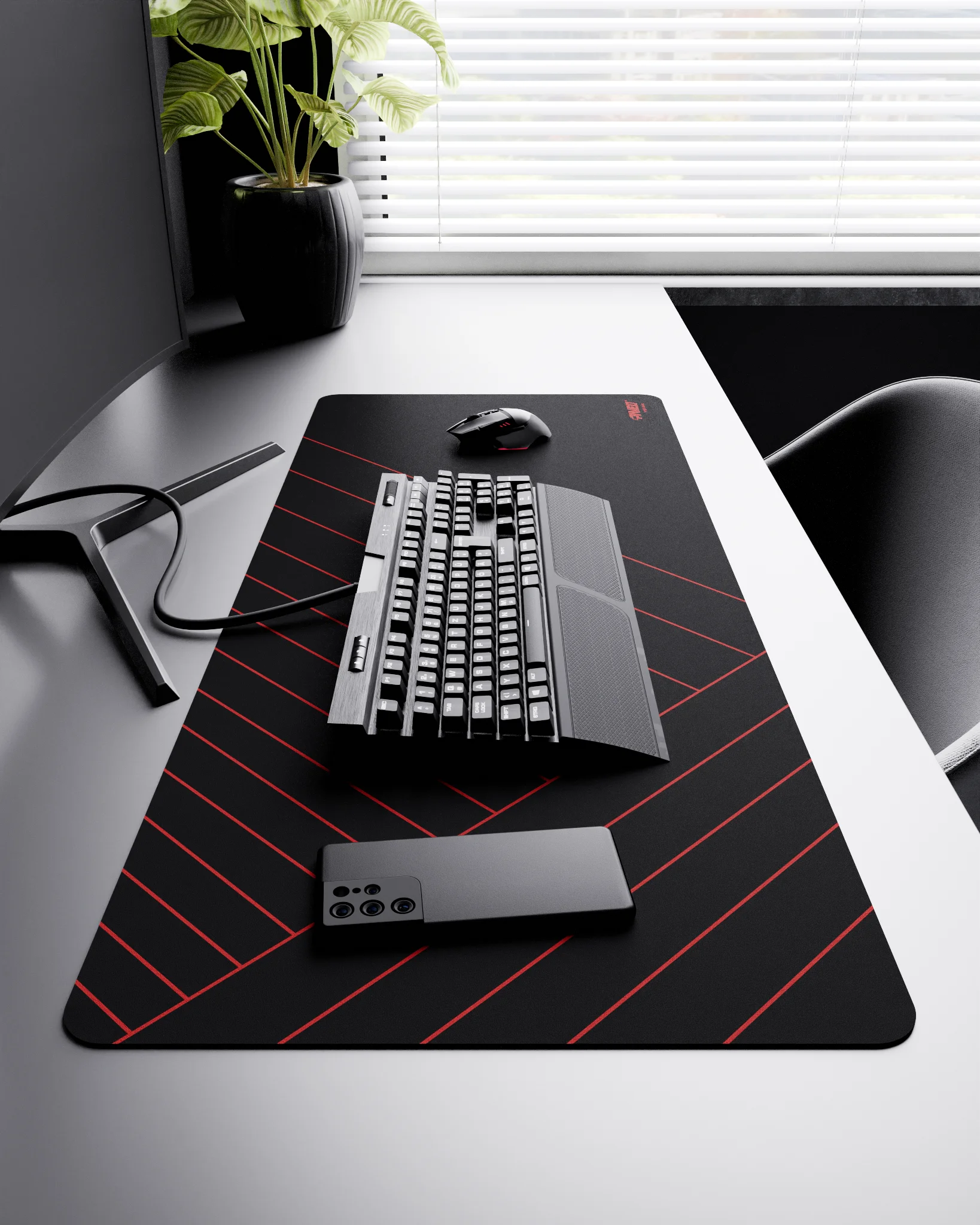 Side view of Night Imperial Zebra XXL deskmat 1000mm x 400mm right-handed layout on minimalist desk with gaming accessories, featuring red diagonal stripe pattern, water-resistant easy-to-clean surface, ultra-lightweight and odour-free base.