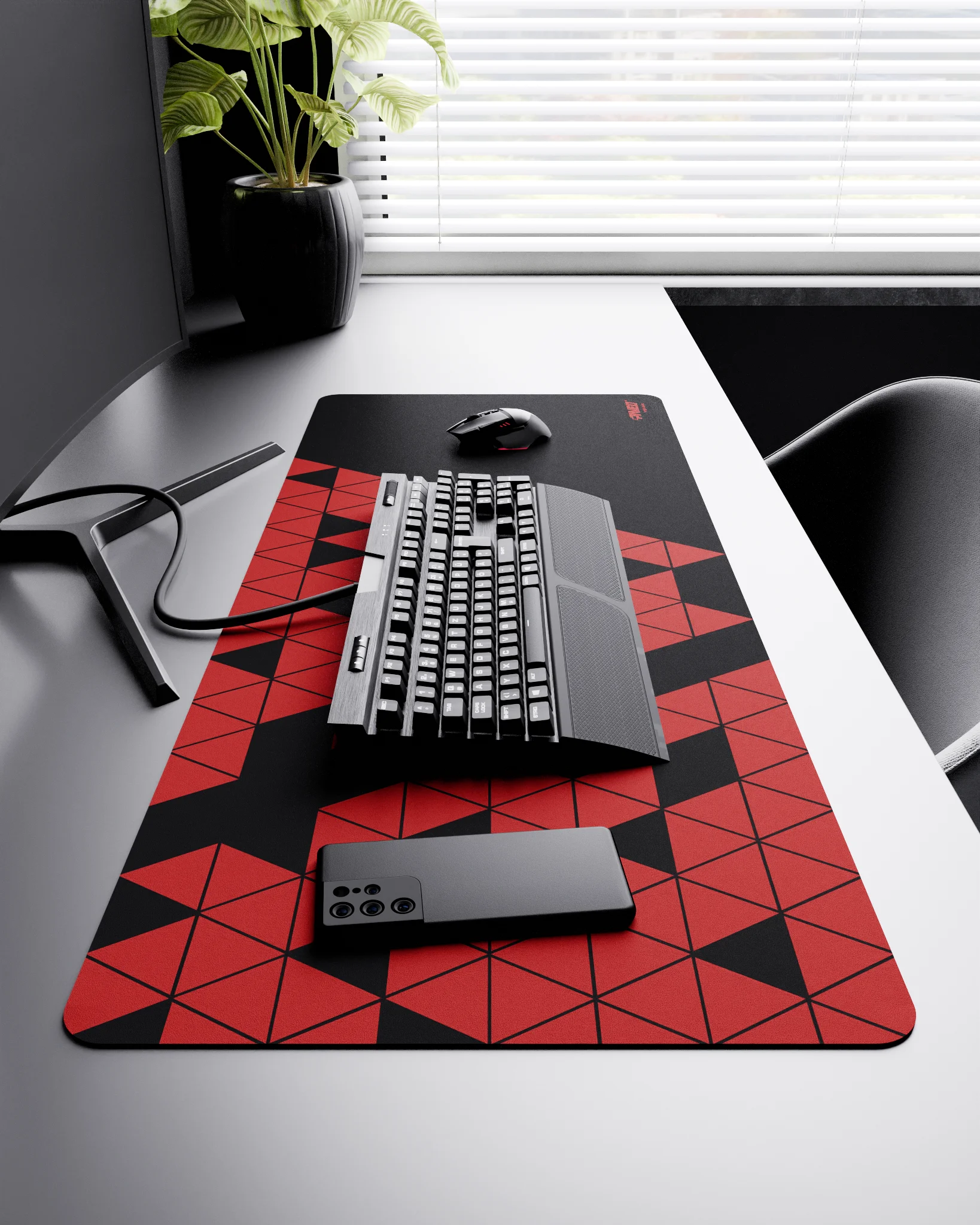 Side view of Night Imperial Prism XXL deskmat 1000mm x 400mm right-handed layout on minimalist desk with gaming accessories, featuring red geometric triangular prism pattern, water-resistant easy-to-clean surface, ultra-lightweight and odour-free base.