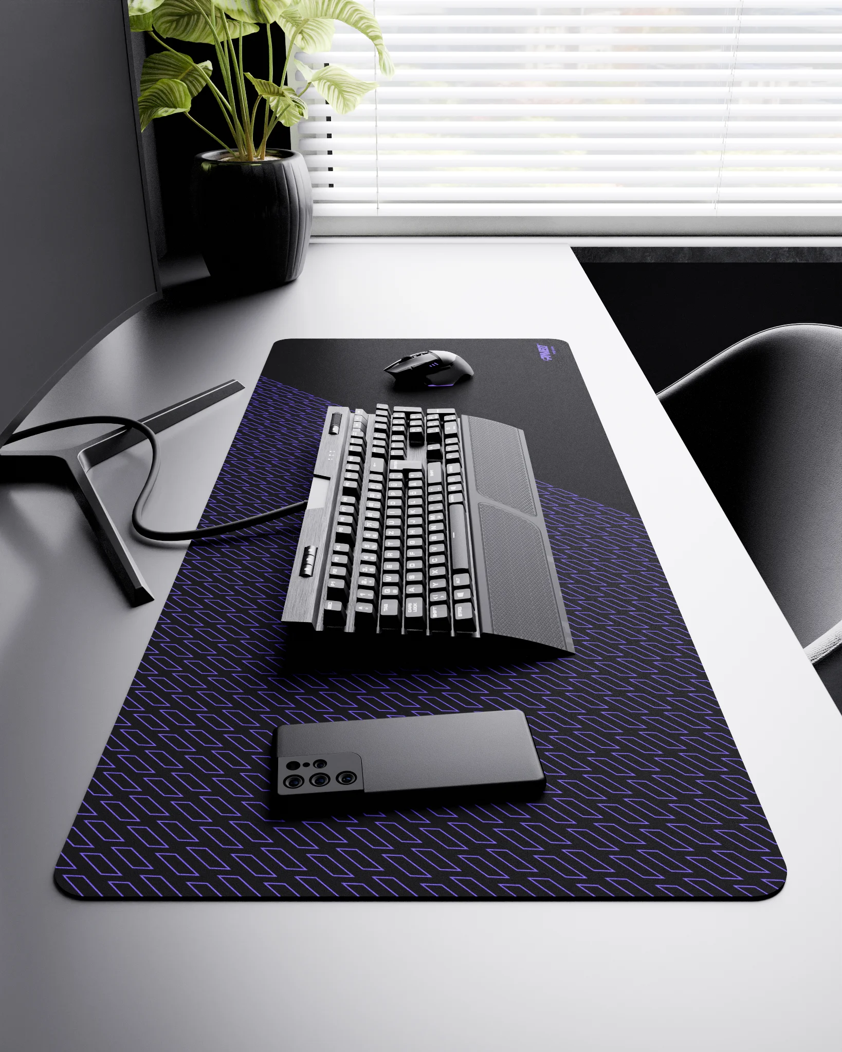 Side view of Night Amethyst Pathfinder XXL deskmat 1000mm x 400mm right-handed layout on minimalist desk with gaming accessories, featuring purple geometric tiled pattern, water-resistant easy-to-clean surface, ultra-lightweight and odour-free base.