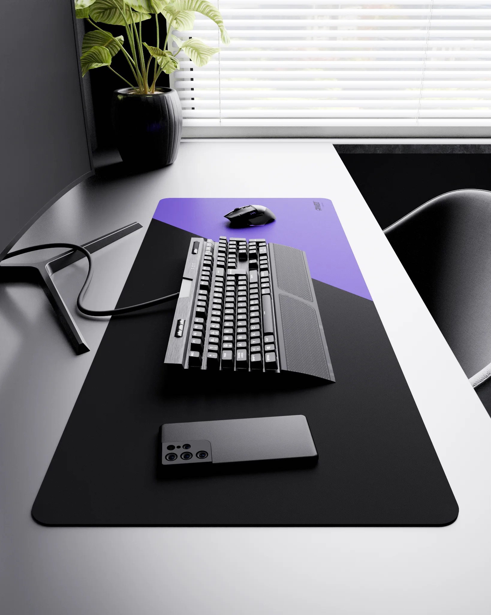 Side view of Amethyst Edge Runner XXL deskmat 1000mm x 400mm right-handed layout on minimalist desk with gaming accessories, featuring purple diagonal split design, water-resistant easy-to-clean surface, ultra-lightweight and odour-free base.