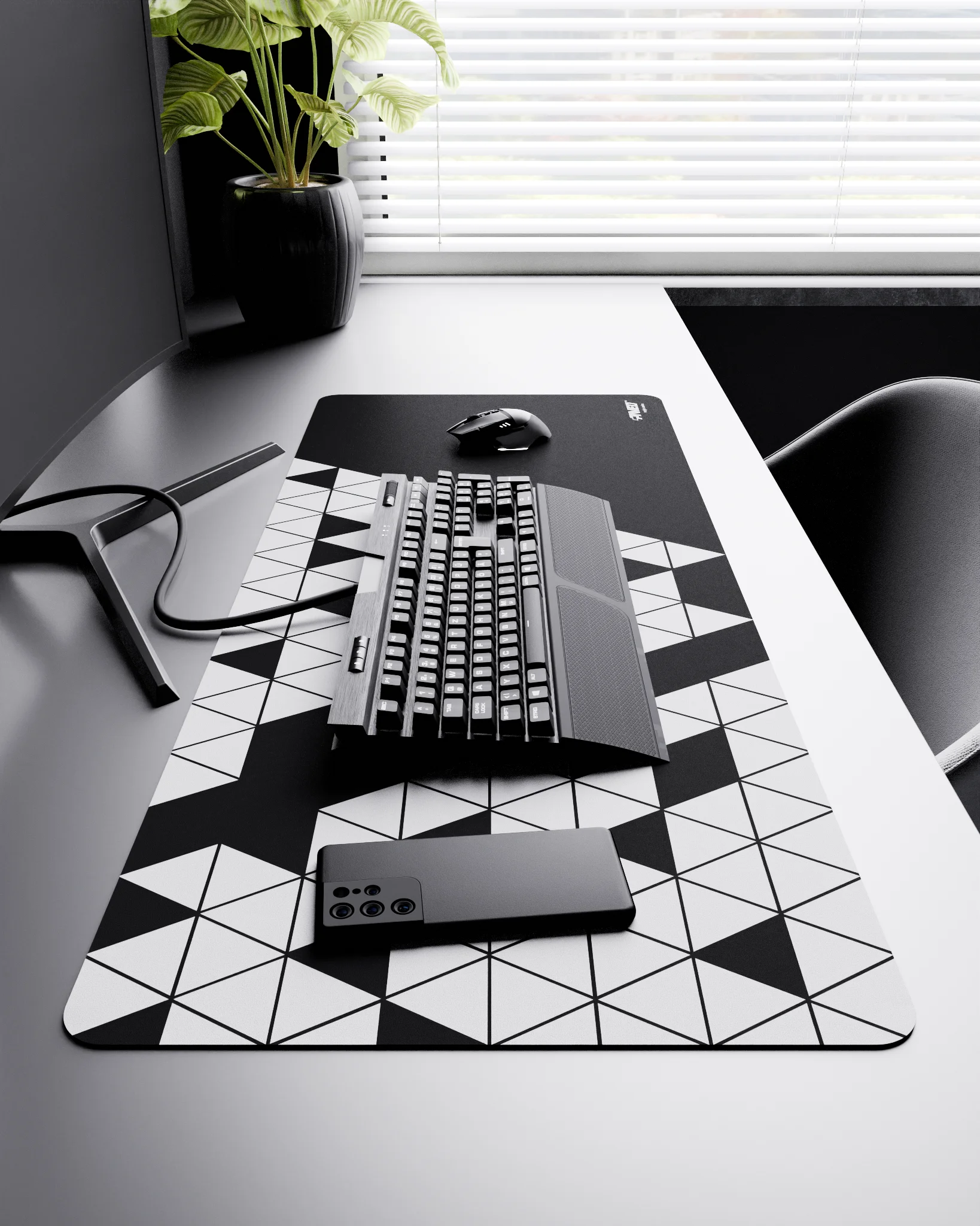 Side view of Night Prism XXL deskmat 1000mm x 400mm right-handed layout on minimalist desk with gaming accessories, featuring white geometric triangular prism pattern, water-resistant easy-to-clean surface, ultra-lightweight and odour-free base.