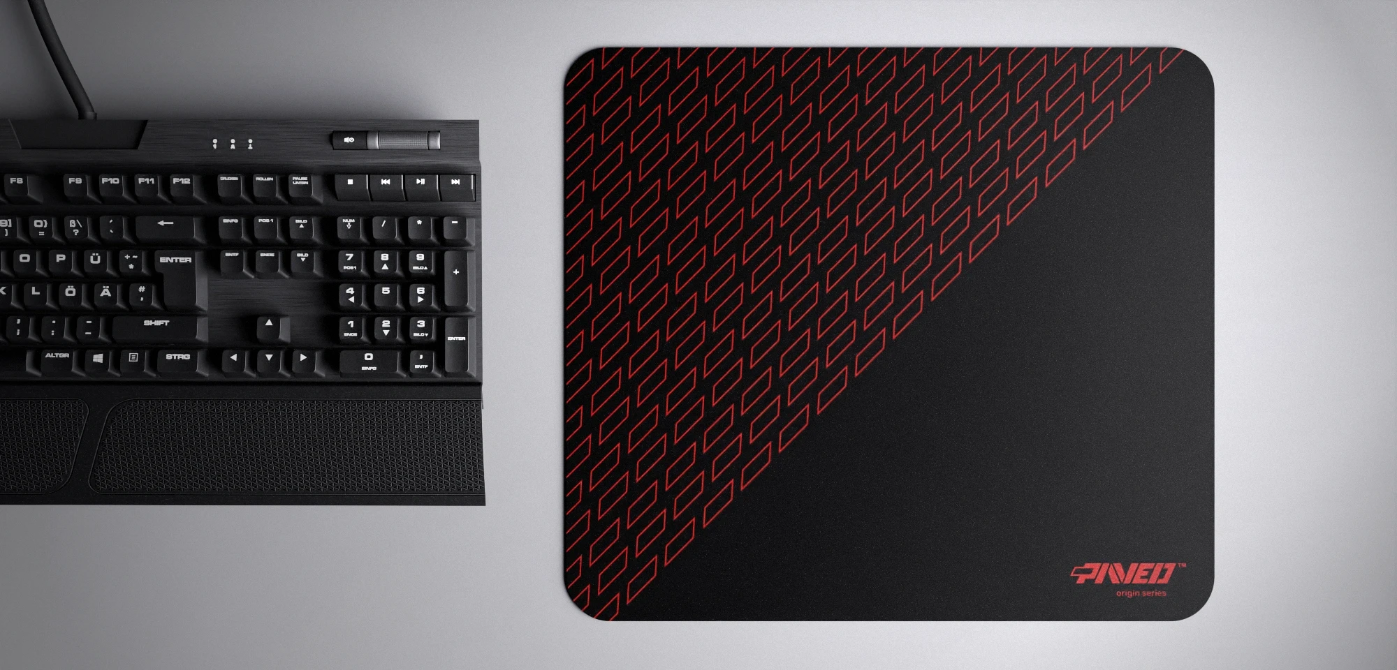 Top view of Night Imperial Pathfinder M size mousepad 360mm x 320mm right-handed variant with geometric tiled pattern in red and black, hydrophobic easy-to-clean surface with antimicrobial properties, shown with full-size mechanical keyboard for scale, 600% lighter with no rubbery odour base, durable stitch-free finish.