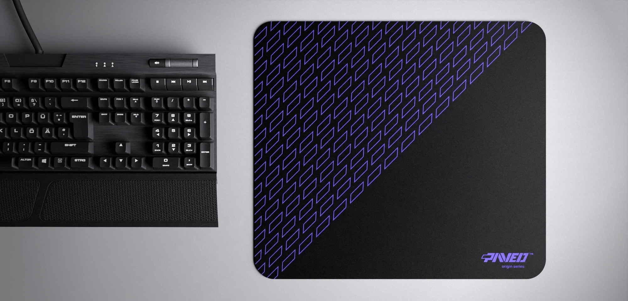 Top view of Night Amethyst Pathfinder M size mousepad 360mm x 320mm right-handed variant with geometric tiled pattern in purple and black, hydrophobic easy-to-clean surface with antimicrobial properties, shown with full-size mechanical keyboard for scale, 600% lighter with no rubbery odour base, durable stitch-free finish.