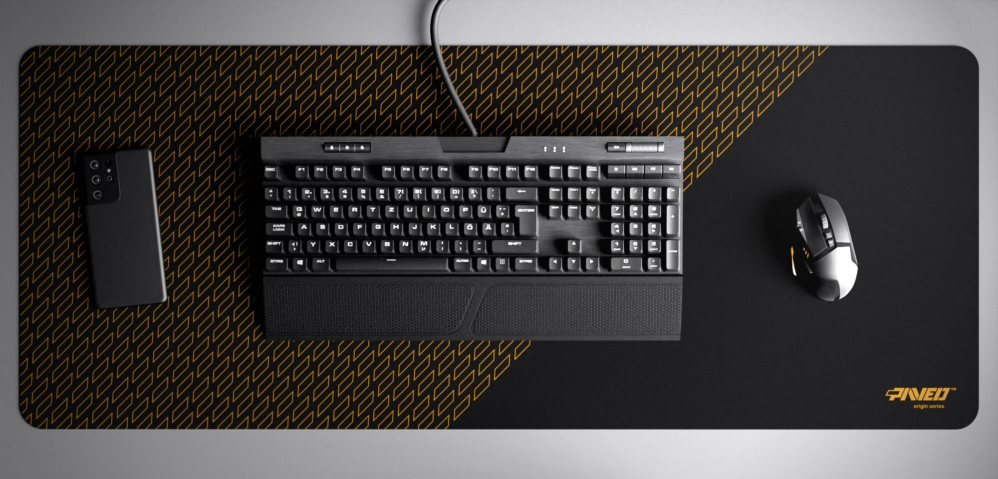 Top view of Night Desert Pathfinder XXL deskmat 1000mm x 400mm right-handed variant with minimalistic geometric tiled pattern in deep yellow and black, hydrophobic easy-to-clean antimicrobial surface, shown with full-size mechanical keyboard, gaming mouse, and smartphone for scale, 600% lighter non-slip base with no rubbery smell, durable stitch-free edges.
