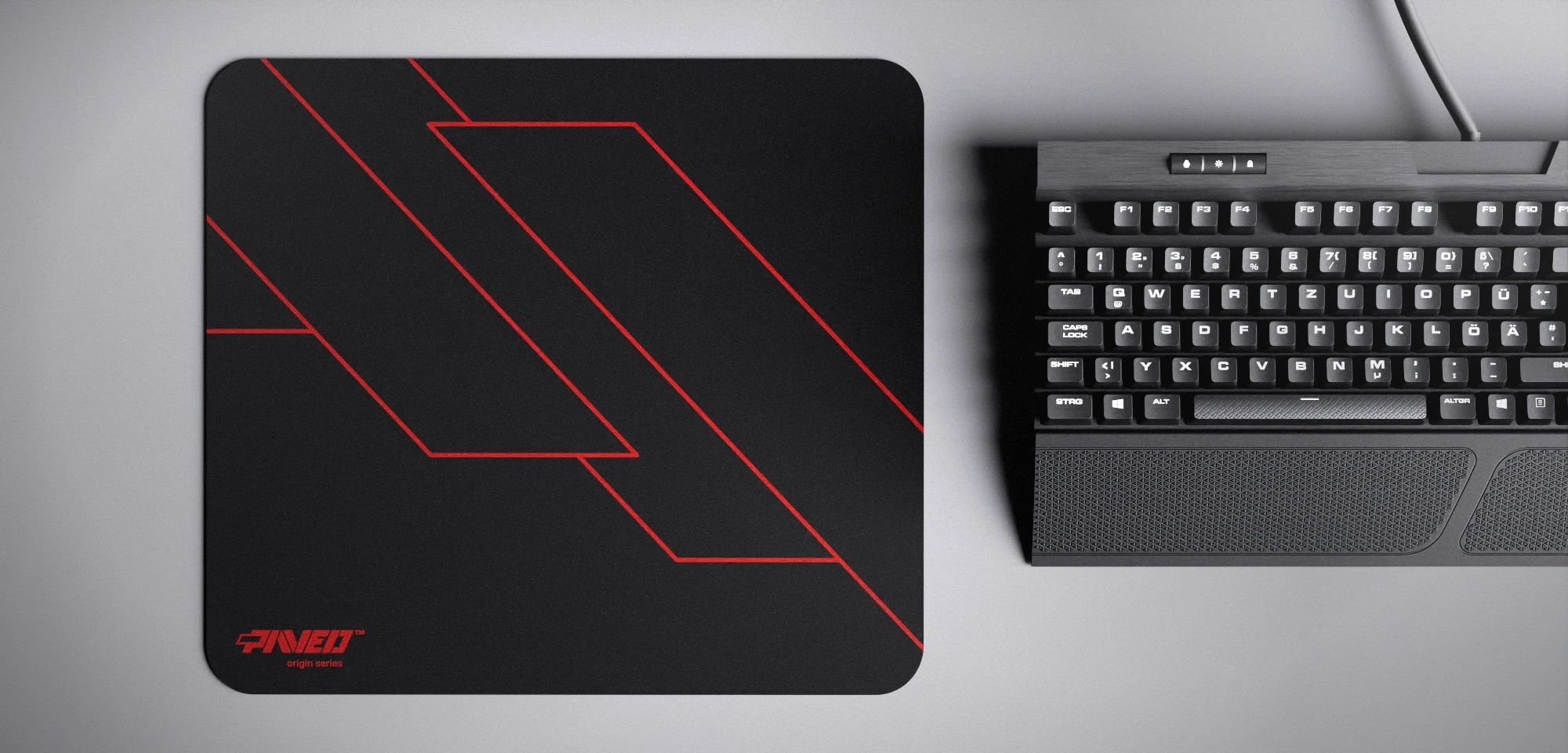 Top view of Night Imperial Formula M size mousepad 360mm x 320mm left-handed variant with minimalistic red geometric angular line pattern on black background, water-resistant antimicrobial polyester surface, shown with full-size mechanical keyboard for scale, ultra-lightweight odour-free AreoFlex base, stitch-free edges.