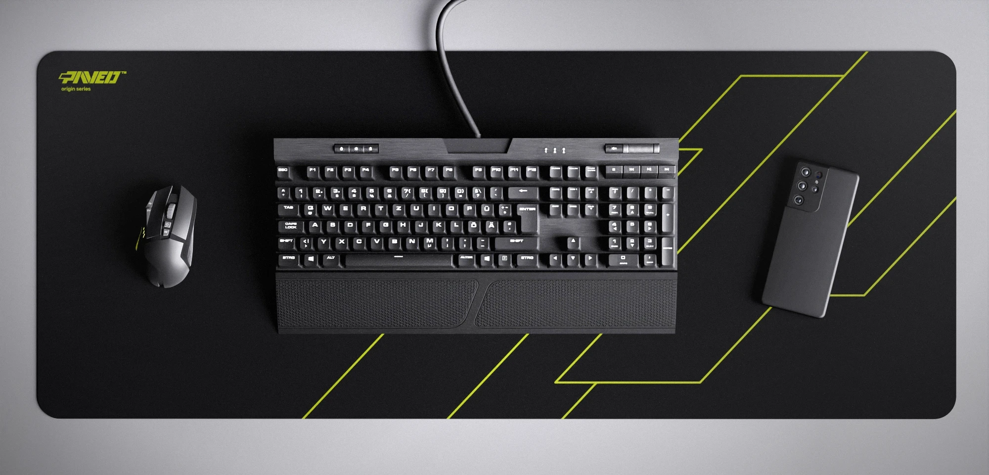 Top view of Night Toxic Formula XXL deskmat 1000mm x 400mm left-handed variant featuring geometric angular line pattern in light green and black, water-resistant antimicrobial polyester surface, shown with full-size mechanical keyboard, gaming mouse, and smartphone for scale, ultra-lightweight odour-free AreoFlex microruber base, stitch-free professional finish.