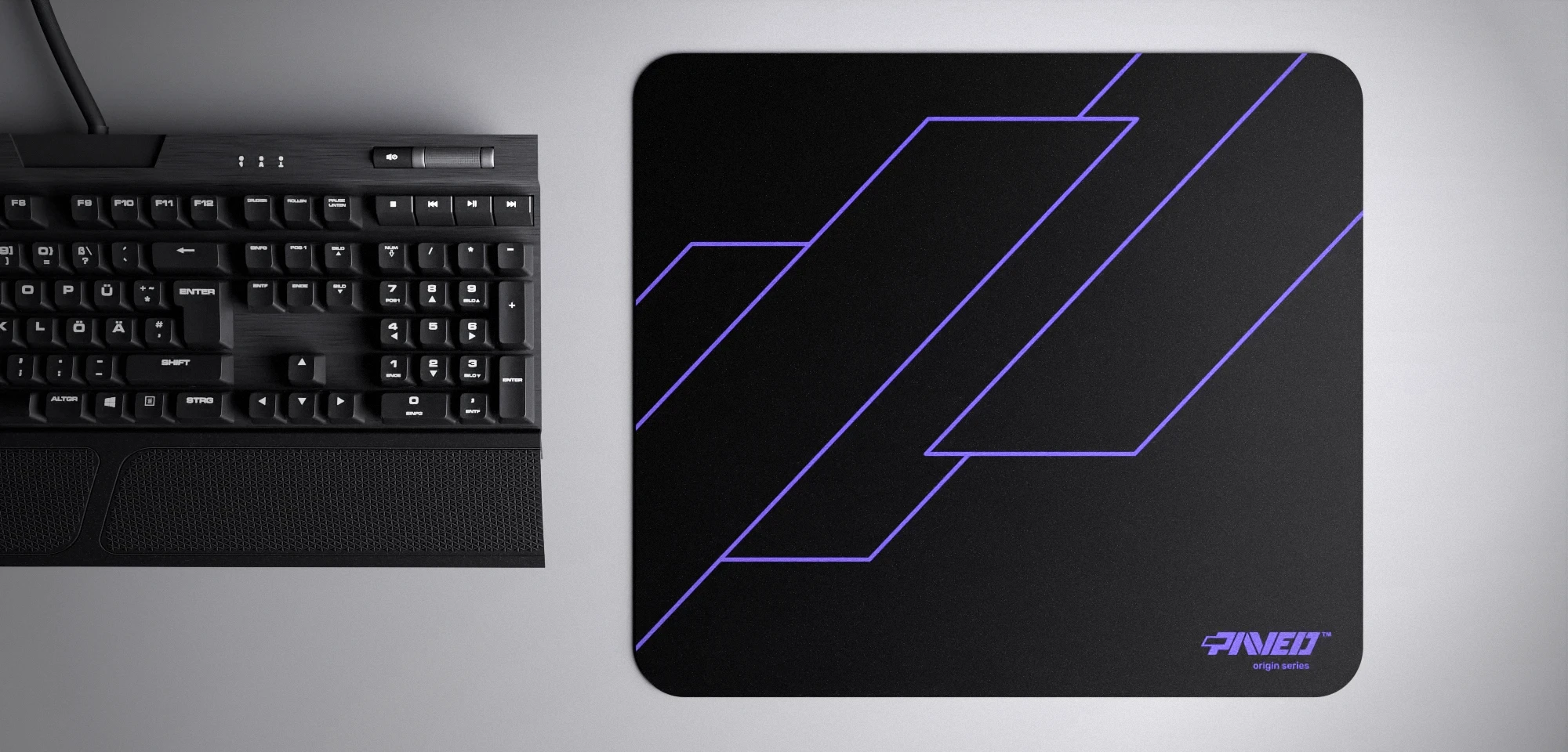 Top view of Night Amethyst Formula M size mousepad 360mm x 320mm right-handed variant with geometric angular line pattern in purple and black, hydrophobic easy-to-clean surface with antimicrobial properties, shown with full-size mechanical keyboard for scale, 600% lighter with no rubbery odour base, durable stitch-free finish.