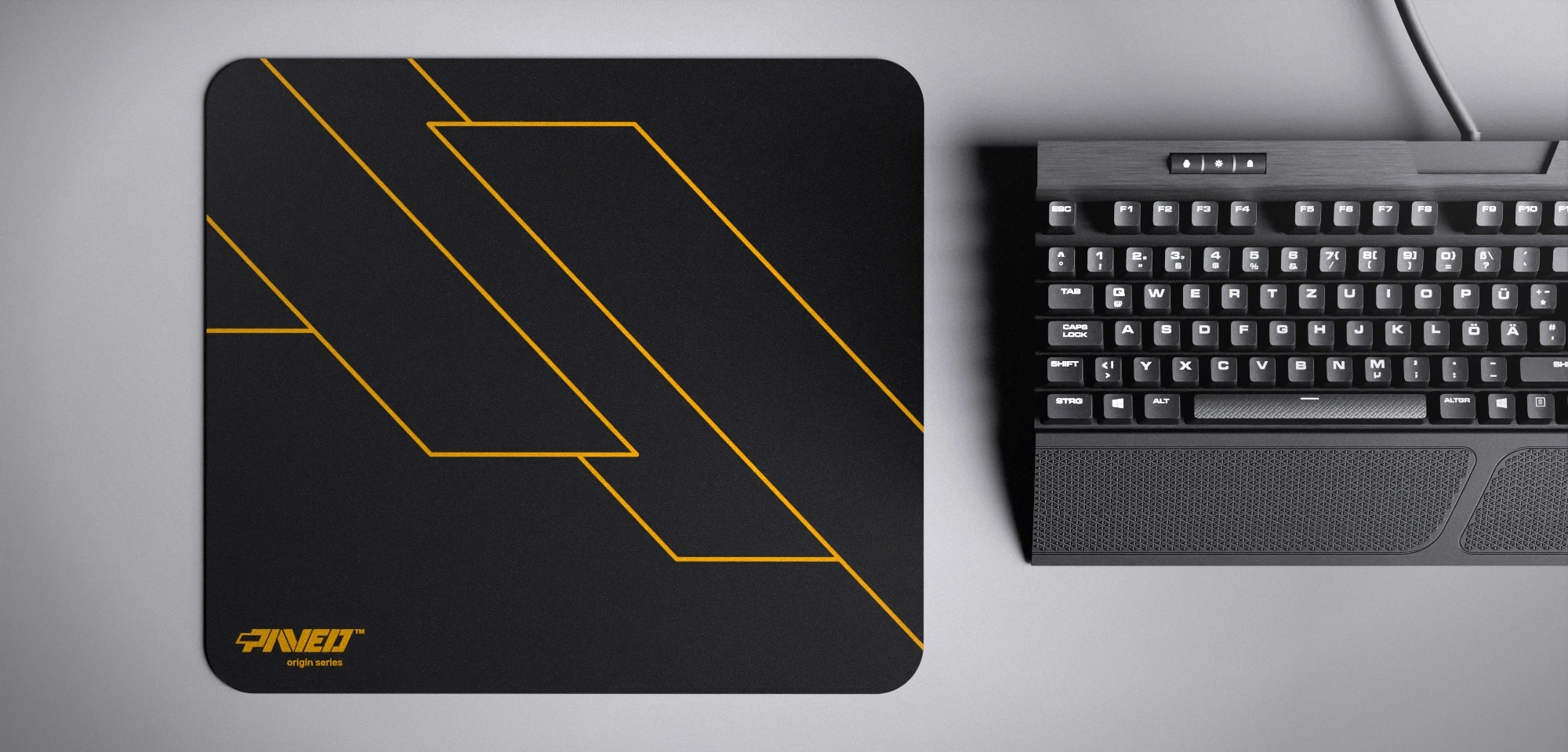 Top view of Night Desert Formula M size mousepad 360mm x 320mm left-handed variant with minimalistic deep yellow geometric angular line pattern on black background, water-resistant antimicrobial polyester surface, shown with full-size mechanical keyboard for scale, ultra-lightweight odour-free AreoFlex base, stitch-free edges.