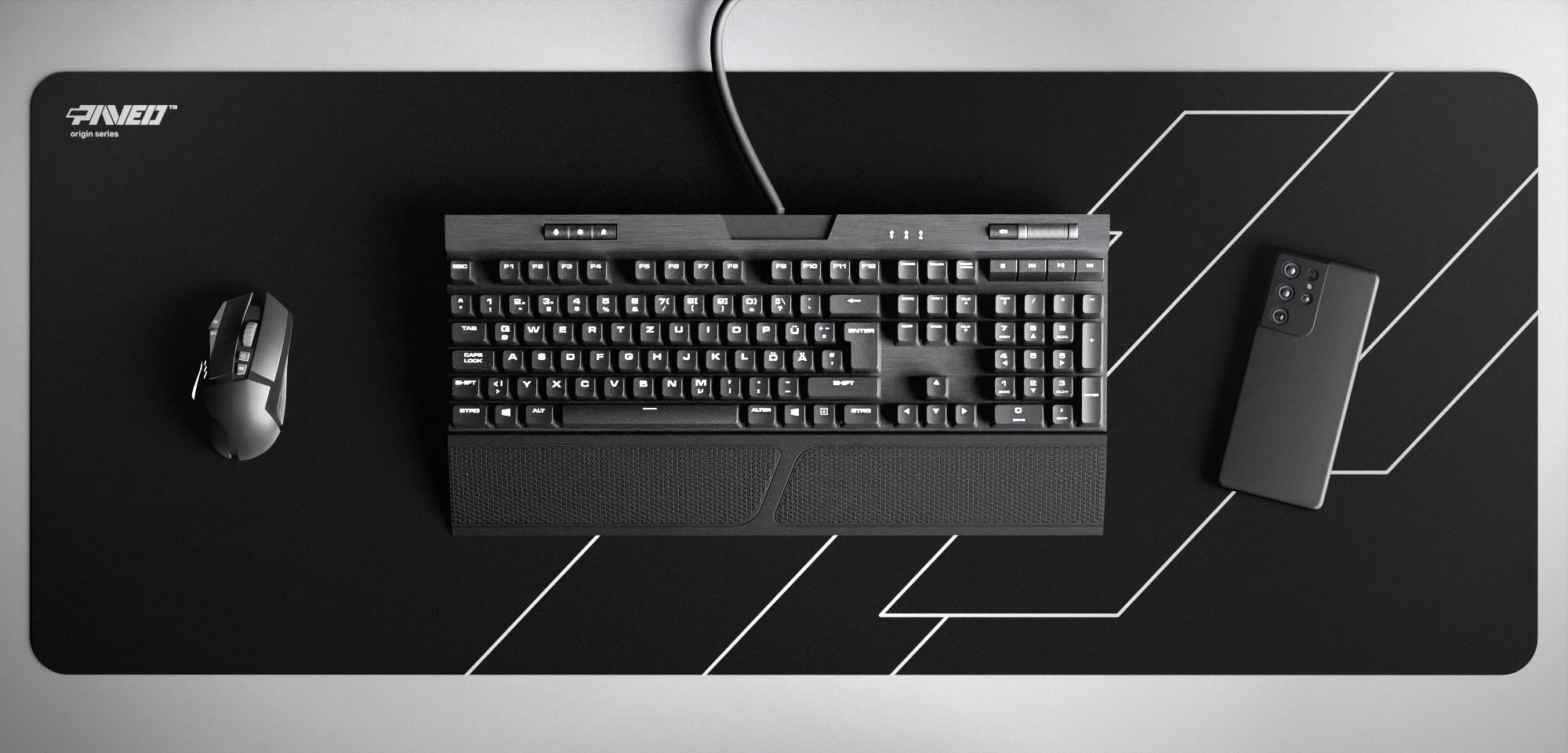 Top view of Night Formula XXL deskmat 1000mm x 400mm left-handed variant featuring geometric angular line pattern in white and black, water-resistant antimicrobial polyester surface, shown with full-size mechanical keyboard, gaming mouse, and smartphone for scale, ultra-lightweight odour-free AreoFlex microruber base, stitch-free professional finish.