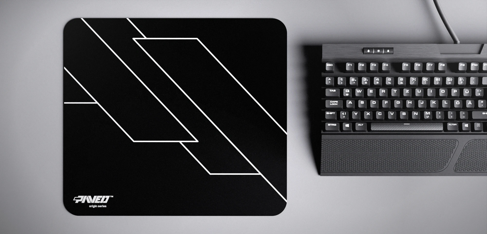 Top view of Night Formula M size mousepad 360mm x 320mm left-handed variant with minimalistic white geometric angular line pattern on black background, water-resistant antimicrobial polyester surface, shown with full-size mechanical keyboard for scale, ultra-lightweight odour-free AreoFlex base, stitch-free edges.