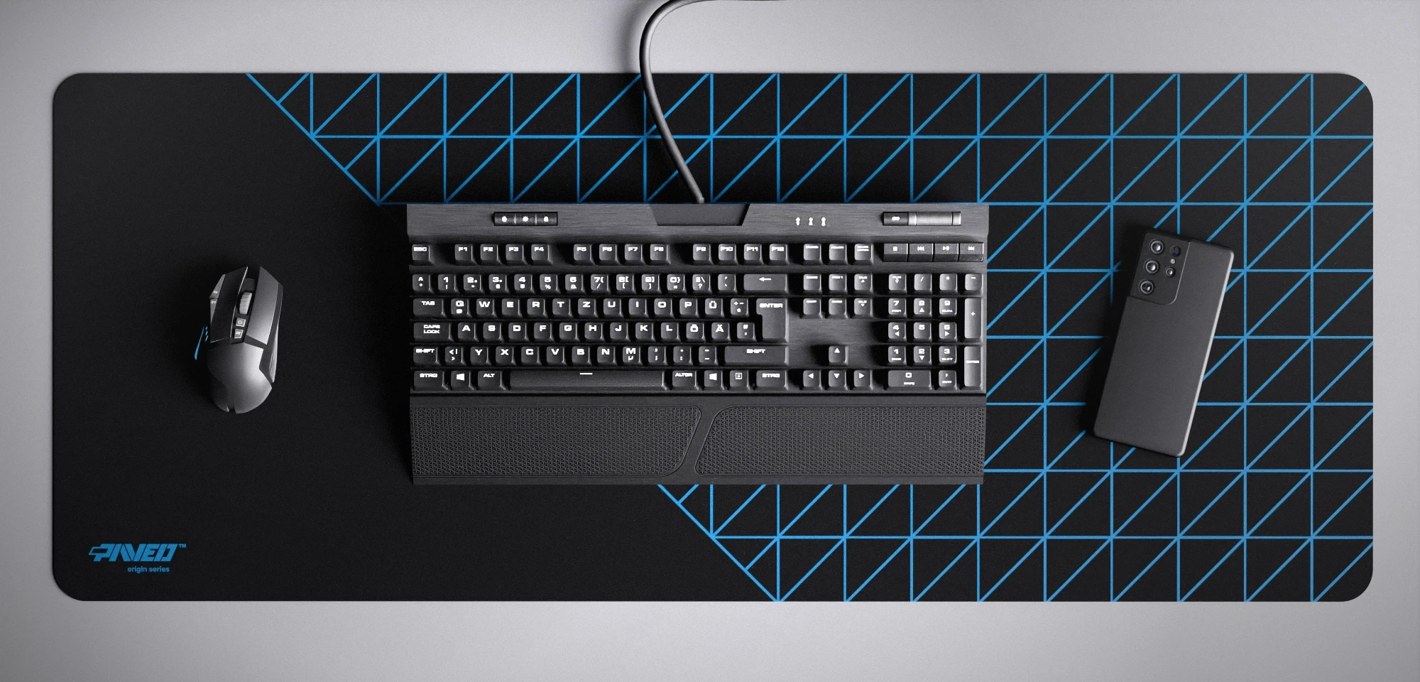 Top view of Night Sky Grid Runner XXL deskmat 1000mm x 400mm left-handed variant featuring geometric grid pattern in blue and black, water-resistant antimicrobial polyester surface, shown with full-size mechanical keyboard, gaming mouse, and smartphone for scale, ultra-lightweight odour-free AreoFlex microruber base, stitch-free professional finish.