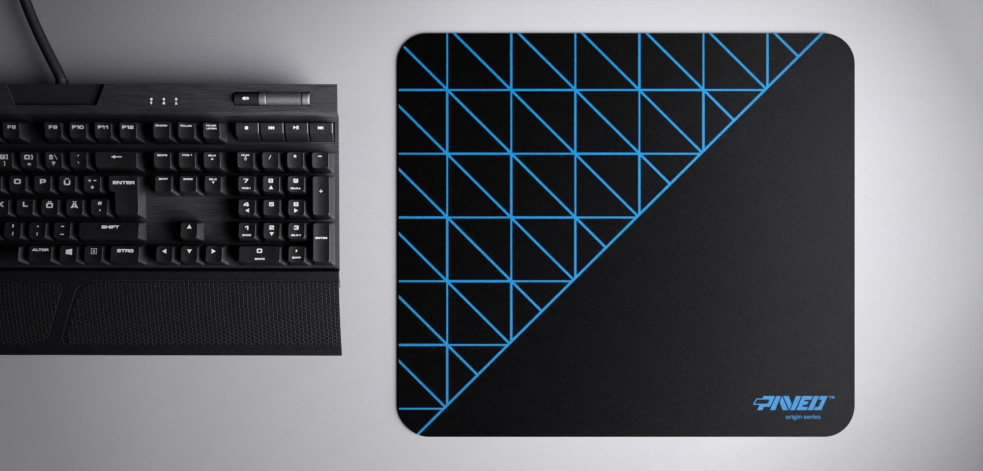 Top view of Night Sky Grid Runner M size mousepad 360mm x 320mm right-handed variant with geometric grid pattern in blue and black, hydrophobic easy-to-clean surface with antimicrobial properties, shown with full-size mechanical keyboard for scale, 600% lighter with no rubbery odour base, durable stitch-free finish.