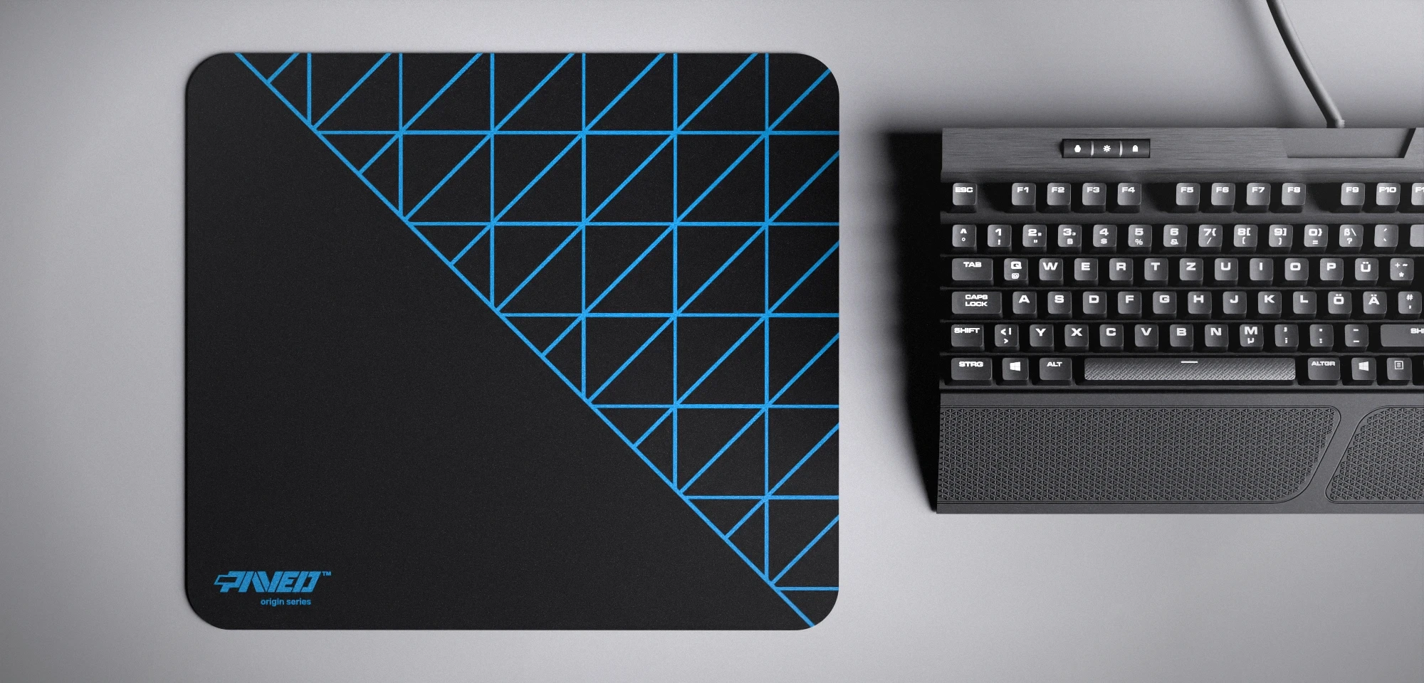 Top view of Night Sky Grid Runner M size mousepad 360mm x 320mm left-handed variant with minimalistic blue geometric grid pattern on black background, water-resistant antimicrobial polyester surface, shown with full-size mechanical keyboard for scale, ultra-lightweight odour-free AreoFlex base, stitch-free edges.
