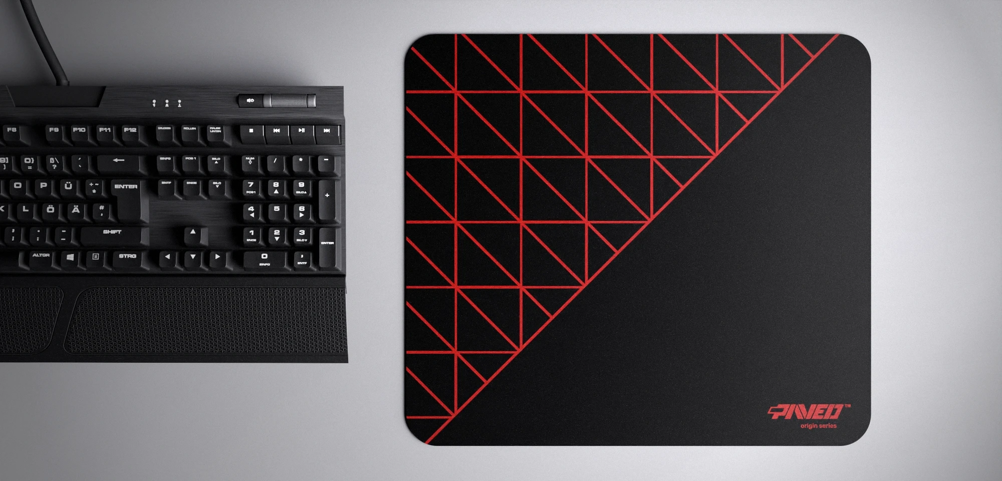 Top view of Night Imperial Grid Runner M size mousepad 360mm x 320mm right-handed variant with geometric grid pattern in red and black, hydrophobic easy-to-clean surface with antimicrobial properties, shown with full-size mechanical keyboard for scale, 600% lighter with no rubbery odour base, durable stitch-free finish.