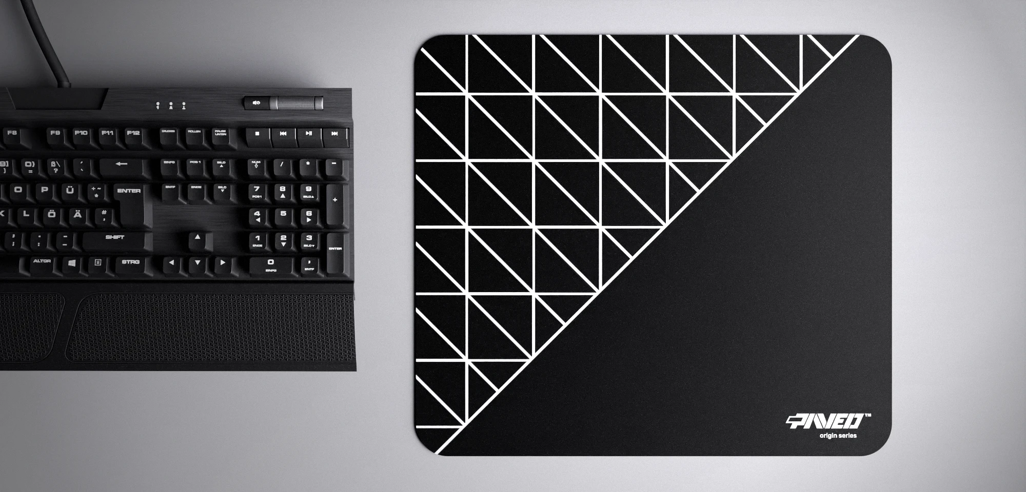 Top view of Night Grid Runner M size mousepad 360mm x 320mm right-handed variant with geometric grid pattern in white and black, hydrophobic easy-to-clean surface with antimicrobial properties, shown with full-size mechanical keyboard for scale, 600% lighter with no rubbery odour base, durable stitch-free finish.