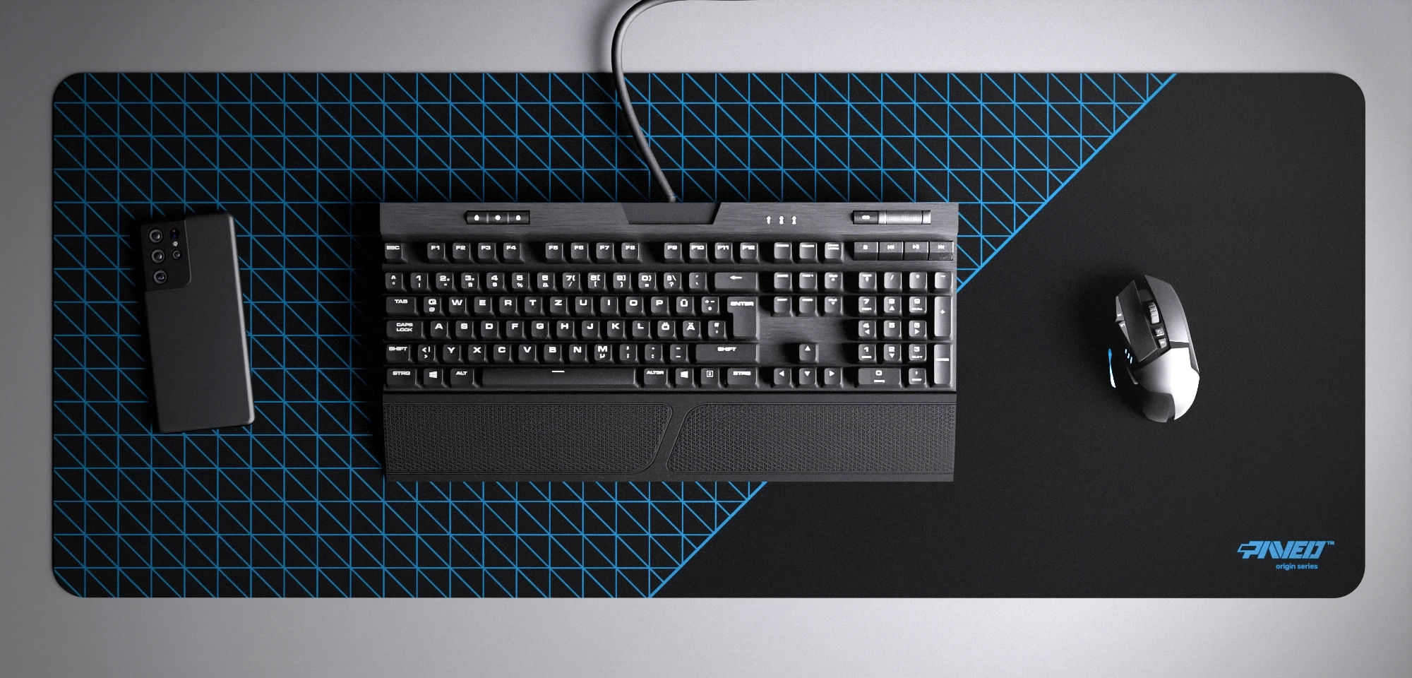 Top view of Night Sky Net Runner XXL deskmat 1000mm x 400mm right-handed variant with minimalistic dense geometric net pattern in blue and black, hydrophobic easy-to-clean antimicrobial surface, shown with full-size mechanical keyboard, gaming mouse, and smartphone for scale, 600% lighter non-slip base with no rubbery smell, durable stitch-free edges.